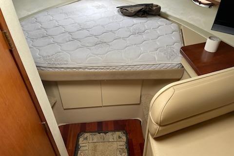 2002 Cruisers Yachts 3372 Express cabin interior with bed and seating area.