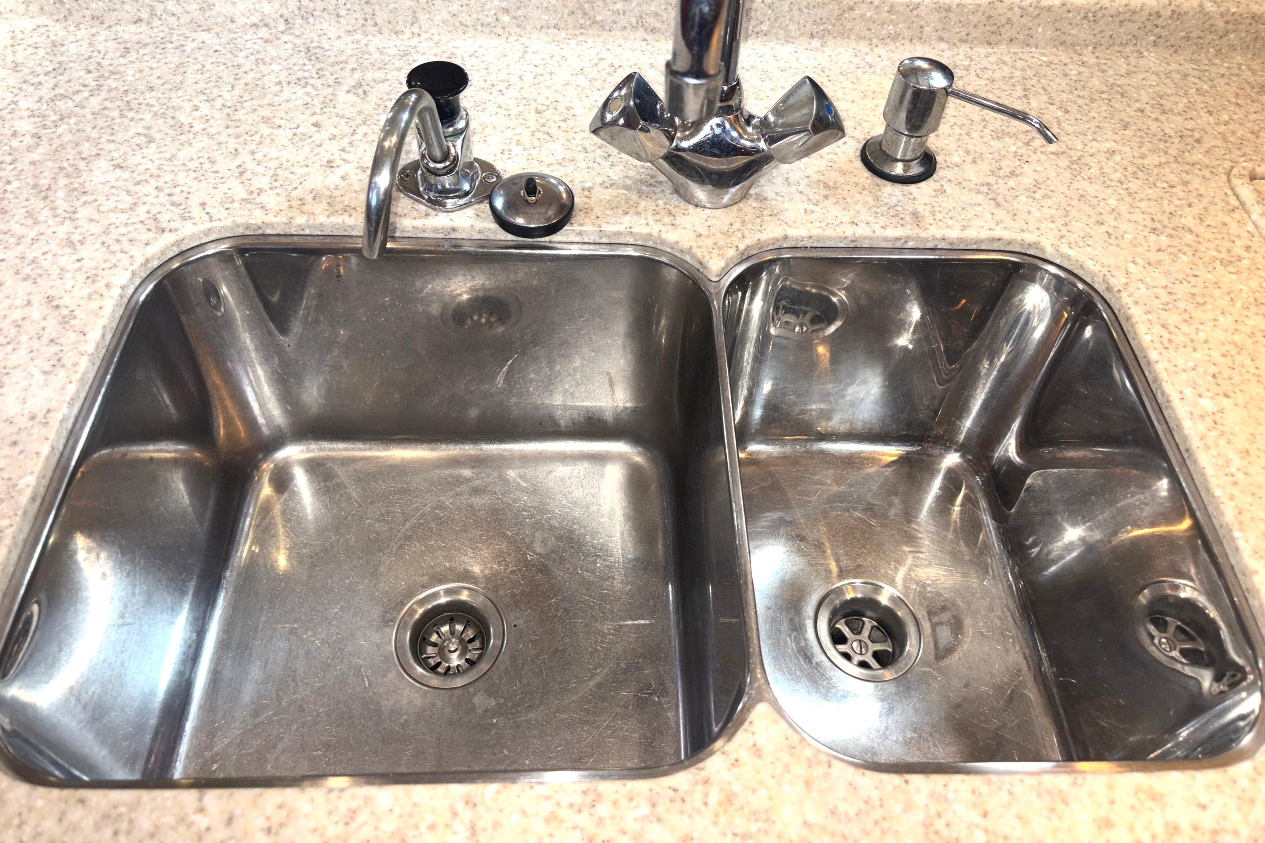 Stainless steel double sink on 2006 Island Packet 440 yacht kitchen countertop.