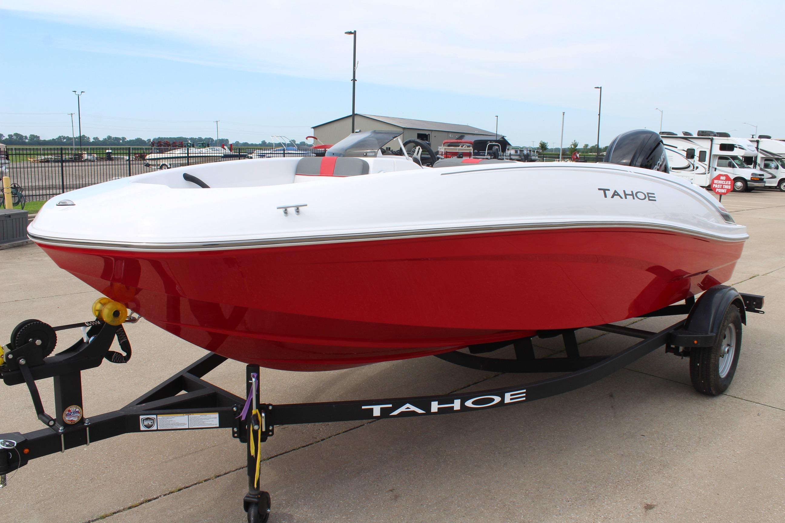 2026 Tahoe T16 boat with red hull on trailer, parked outdoors.