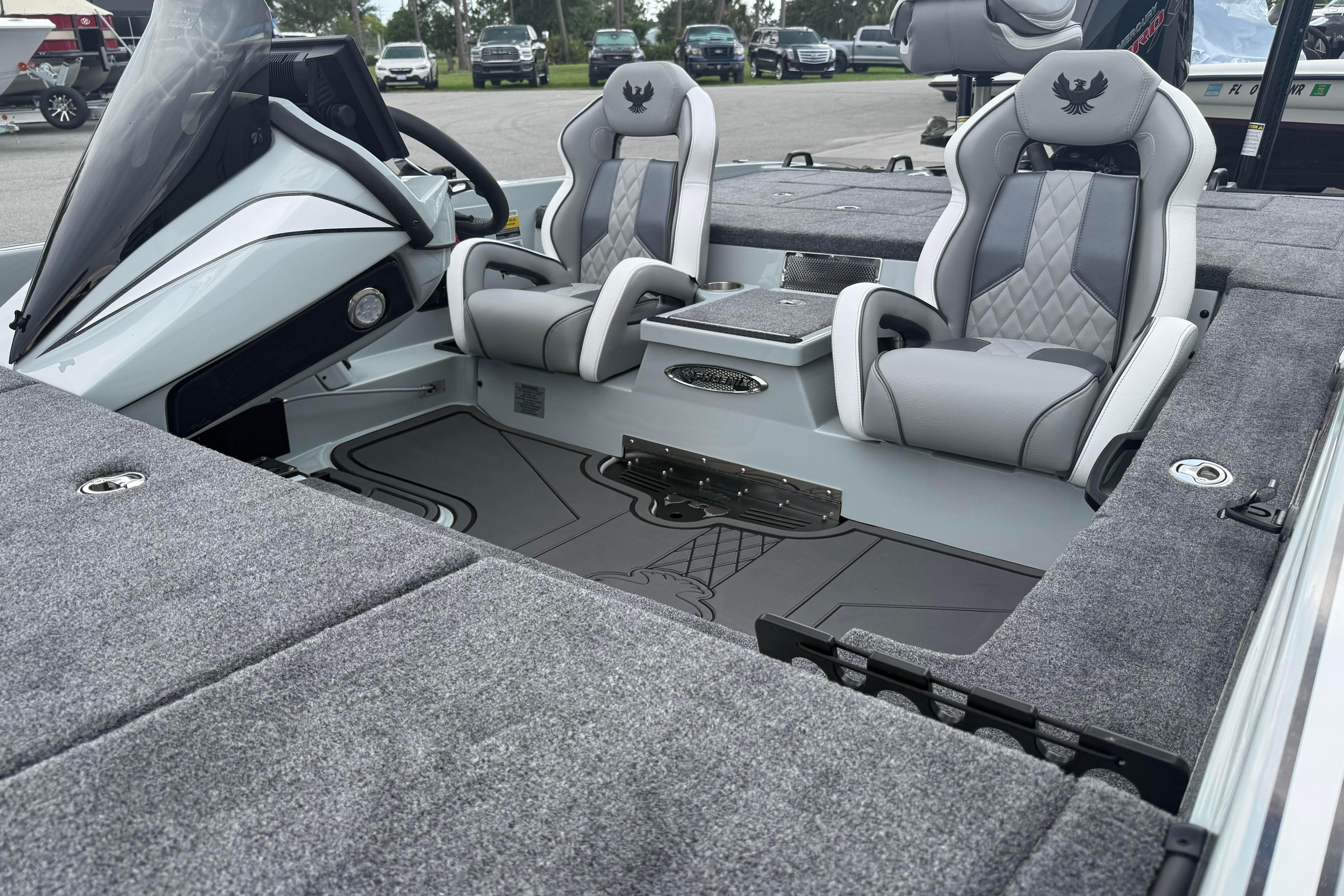 Interior of 2027 Phoenix 921 Elite X II boat with plush seating and modern dashboard.