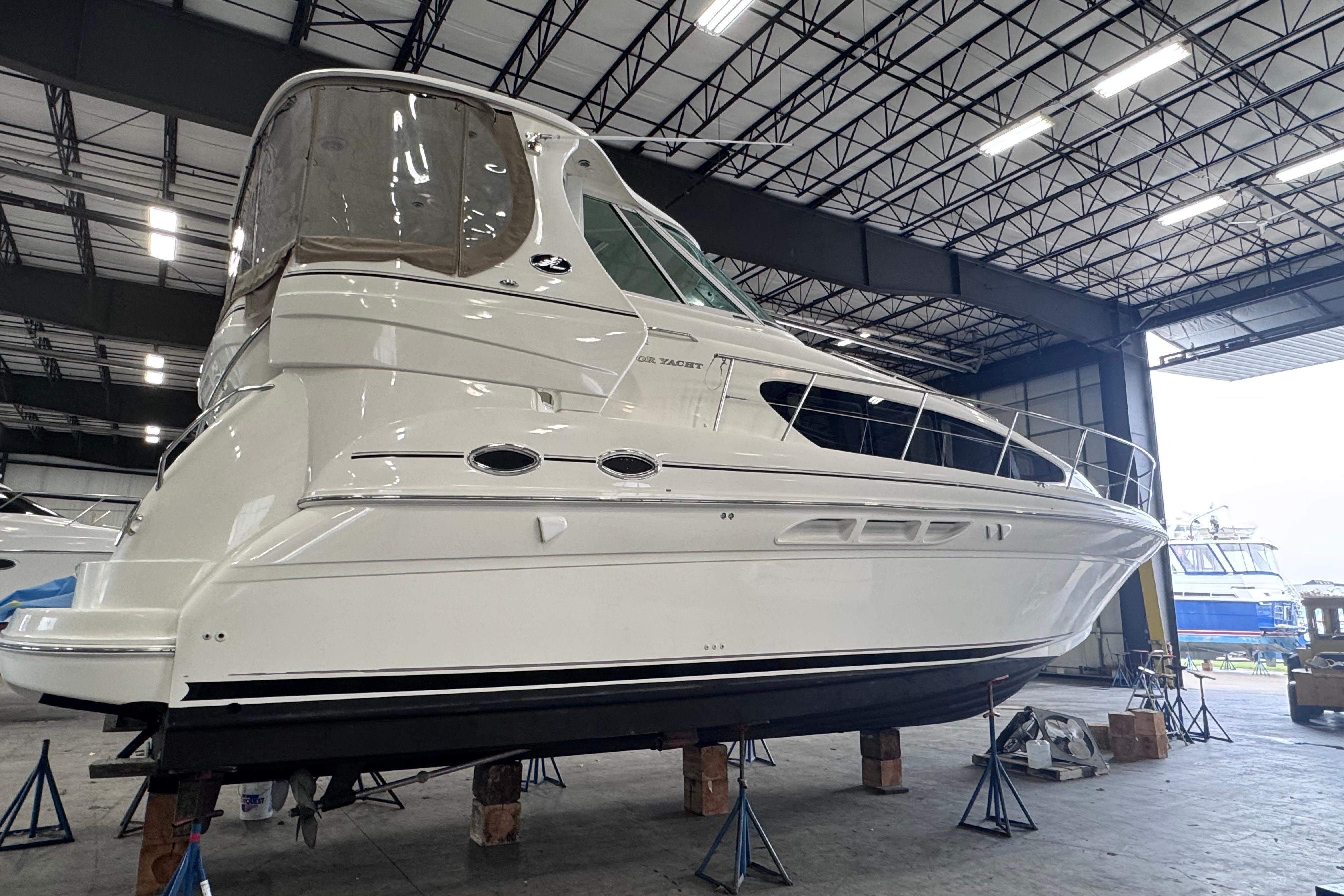 2004 Sea Ray 390 Motor Yacht in a spacious indoor marina setting.