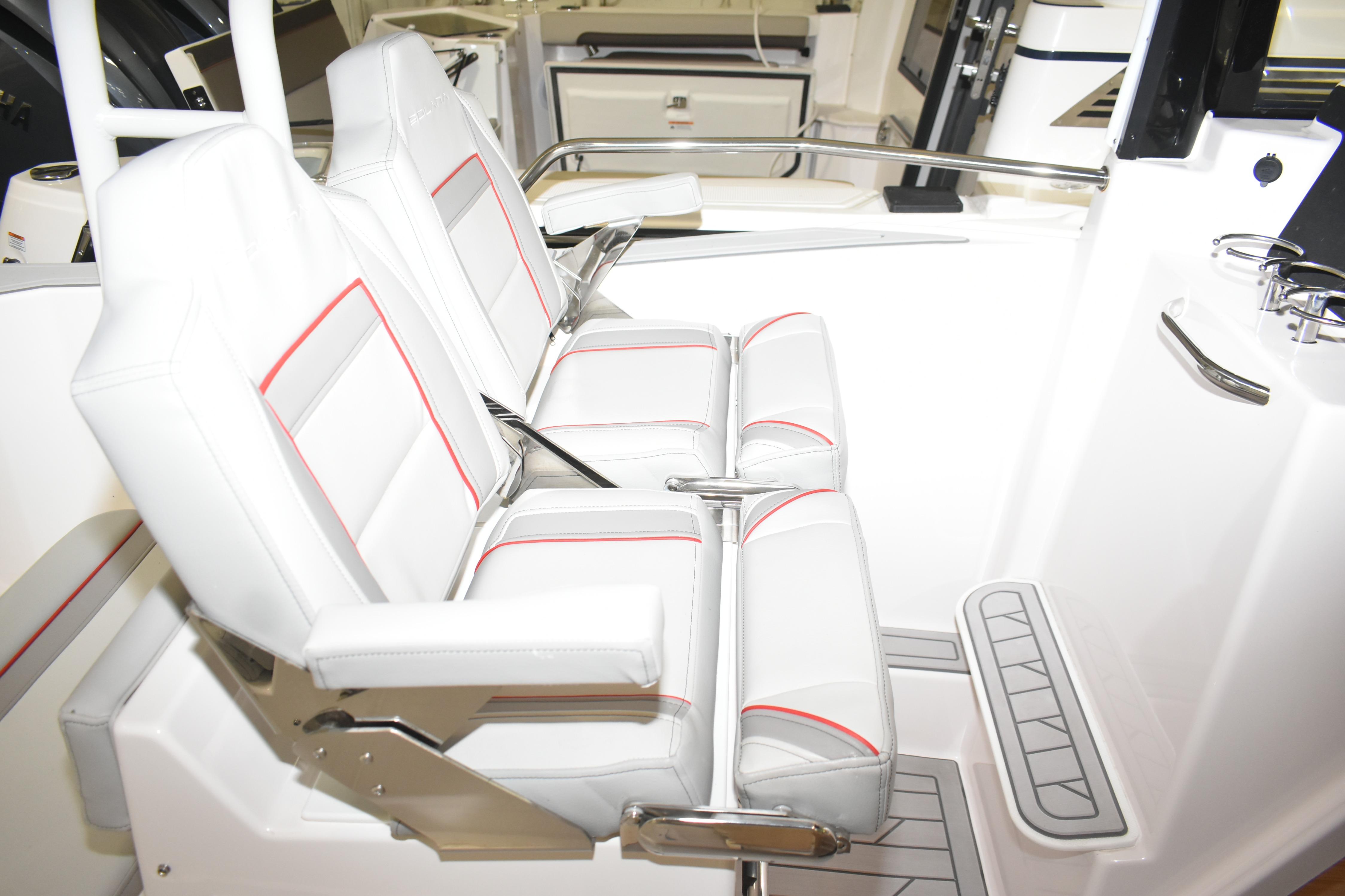 Luxury seating in 2025 Solara S-310 CW boat, featuring white upholstery with red accents.