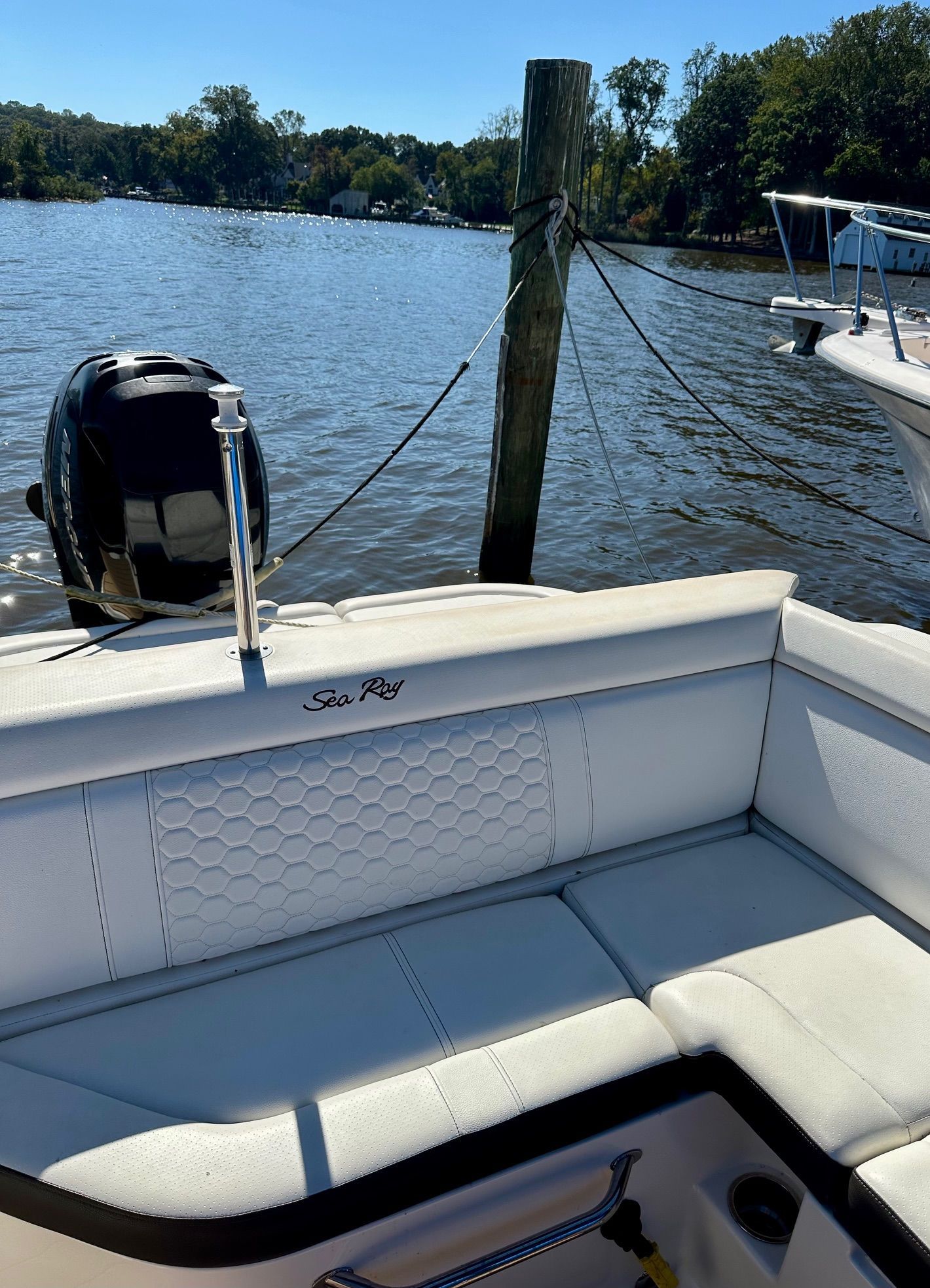 The image shows the stern of a 2018 Sea Ray SDX 270 Outboard docked by the water.