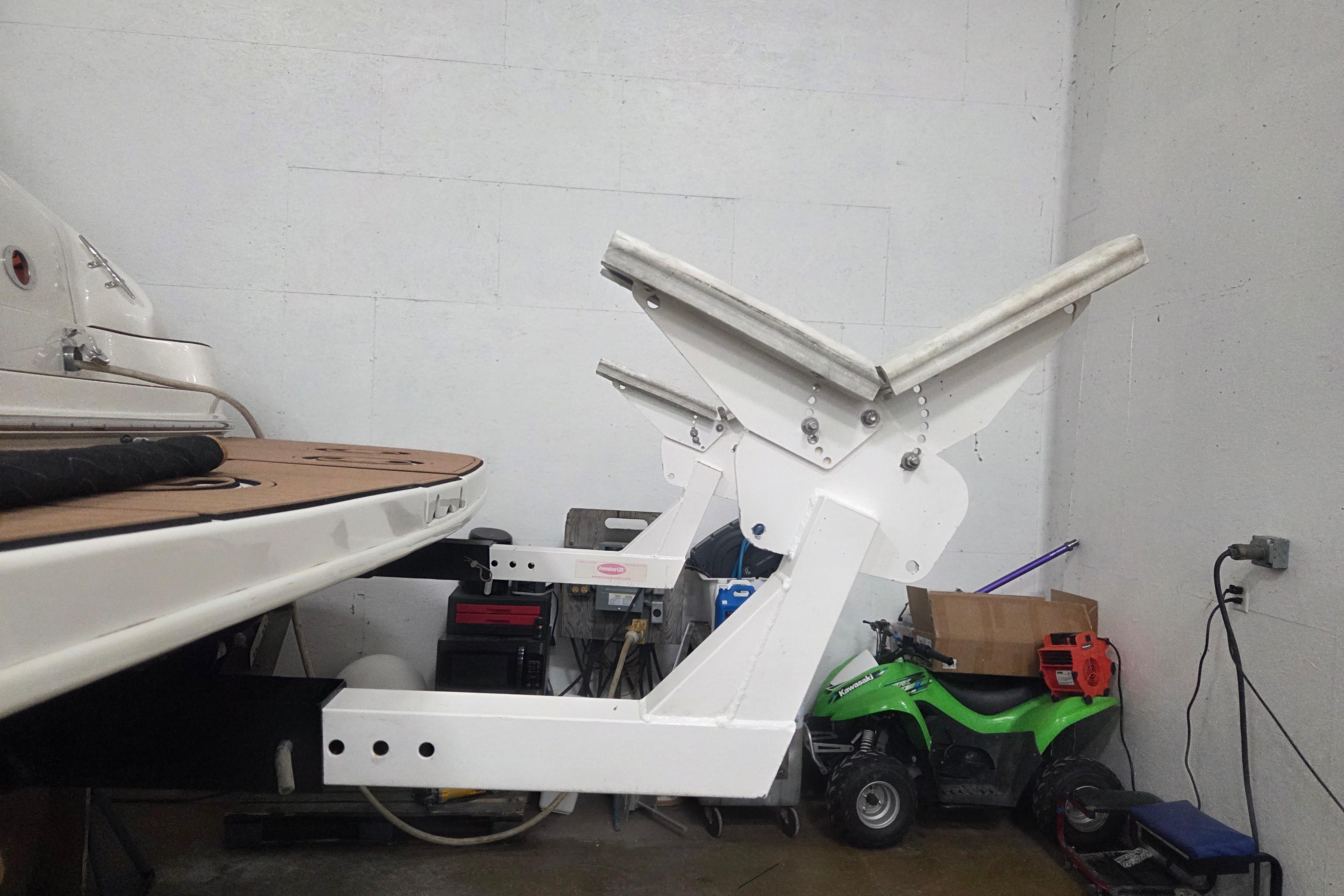 2000 Sea Ray Sundancer 540 boat in garage with custom lift mechanism.