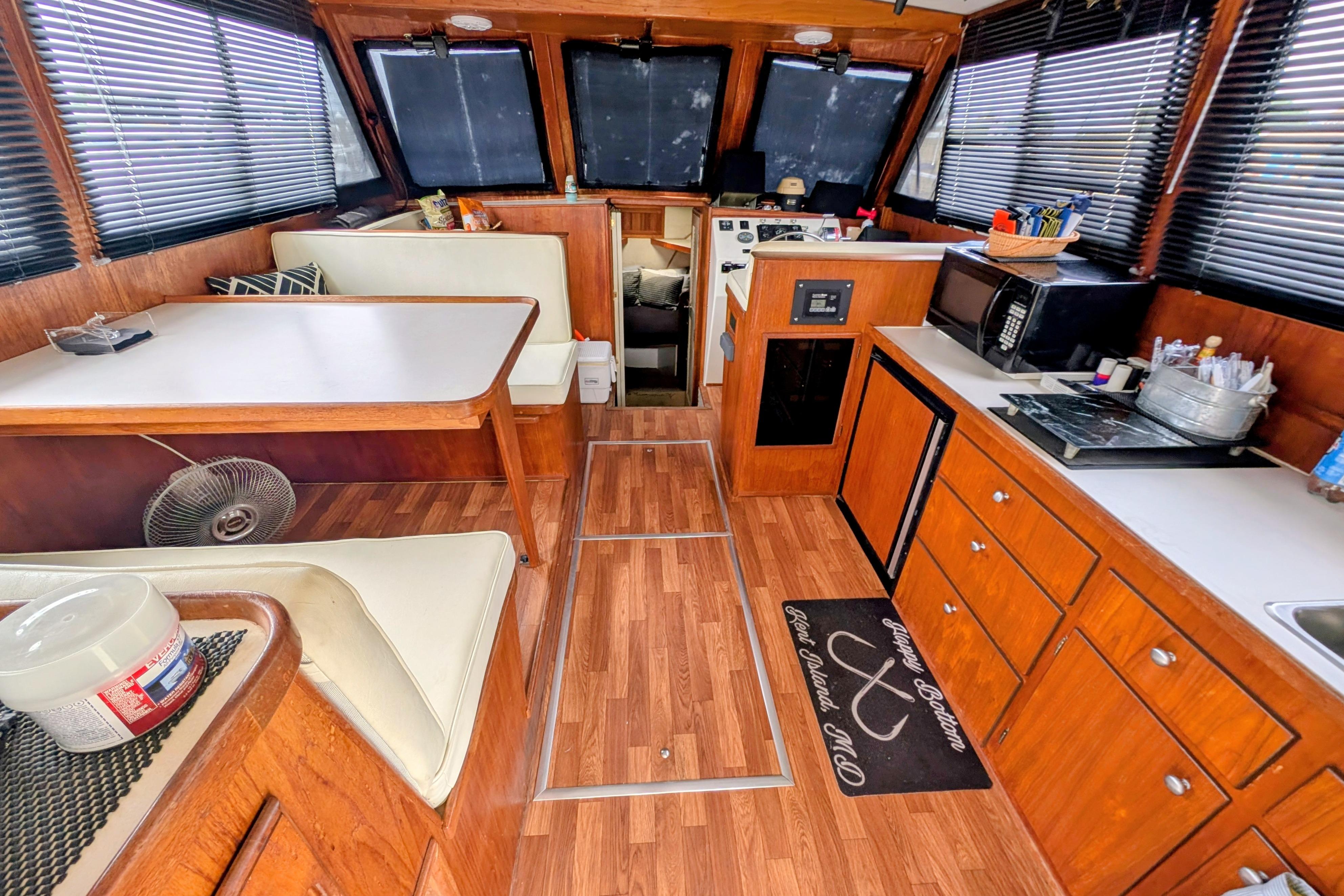 Interior of a 1998 Markley 46 boat with wood paneling and dining area.