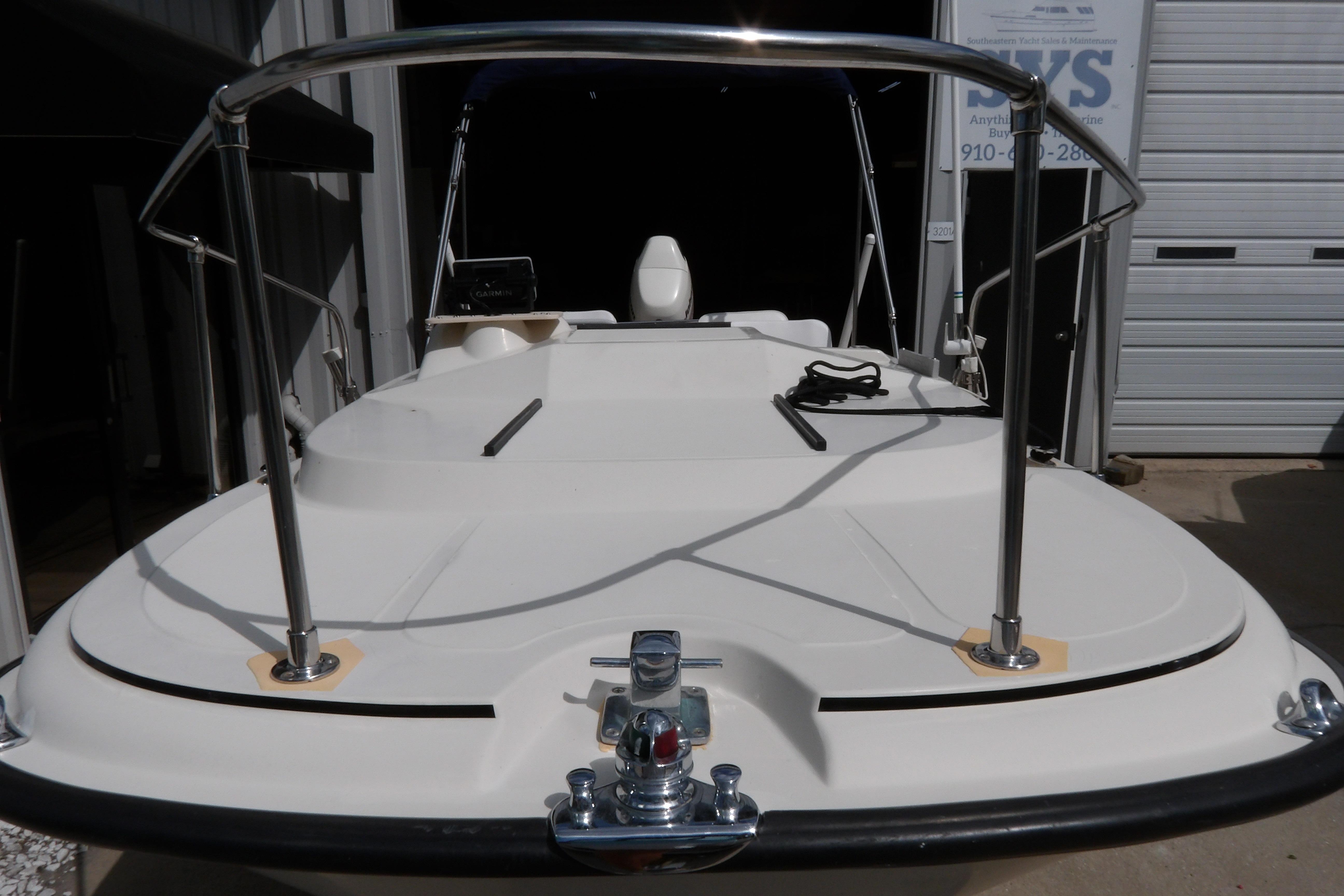 1978 Boston Whaler 21 Revenge boat, docked, showcasing deck and railing.