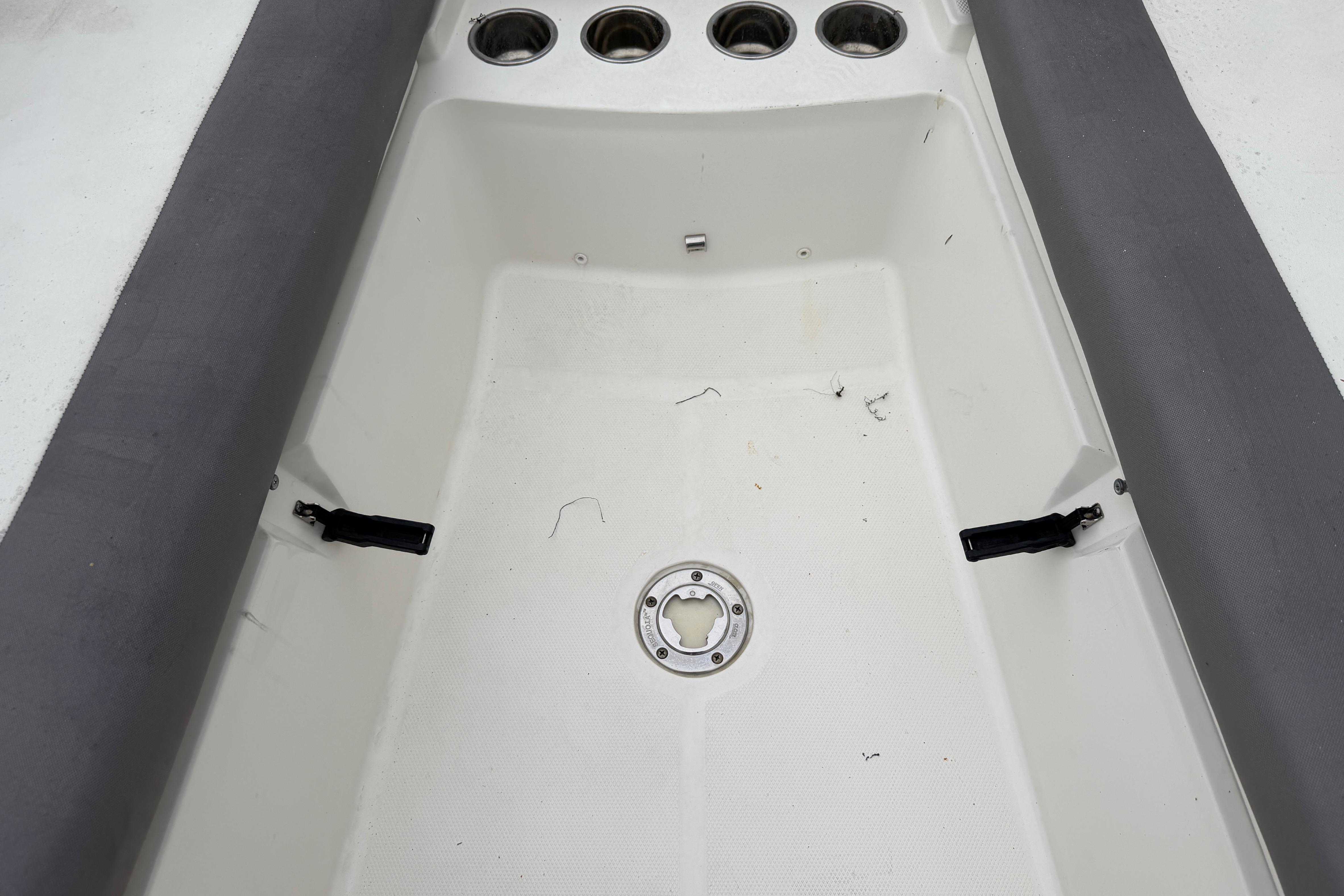 2019 World Cat 230 DC boat interior with cup holders and seating area.