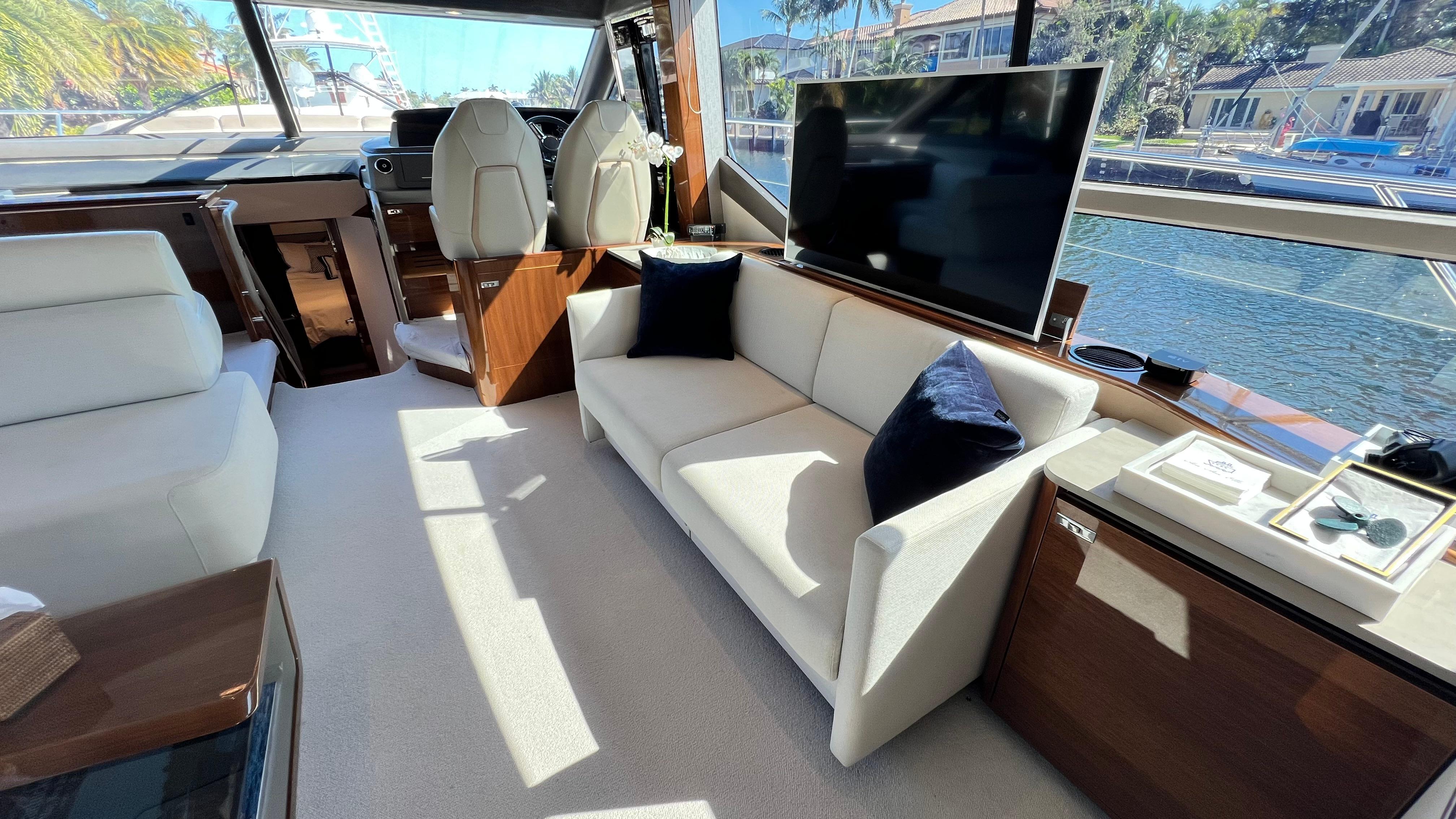 Luxurious interior of 2019 Princess F62 yacht with modern seating and large windows.