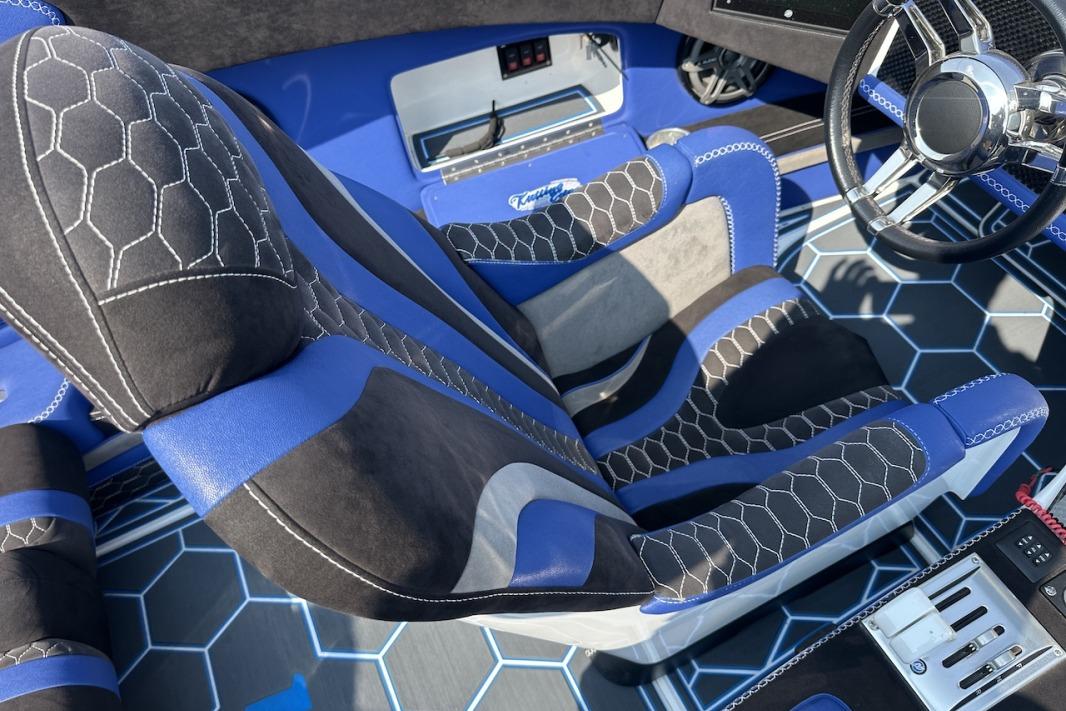 Luxurious interior of 2018 Wright Performance 420 with hexagonal-patterned seats and modern steering wheel.