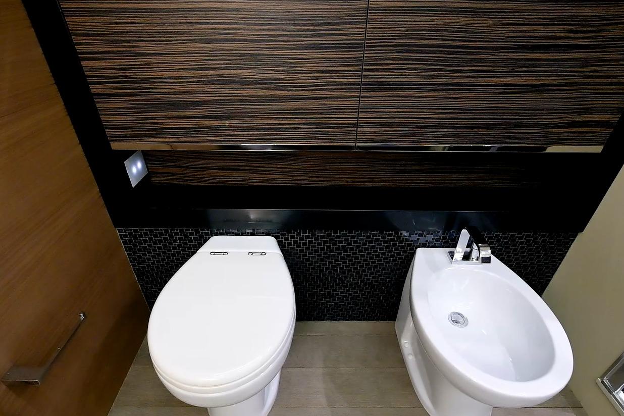 Luxury bathroom on 2015 Pershing 92 yacht with modern toilet and bidet.