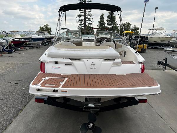 2013 Regal 1900 boat with swim platform, docked at marina.