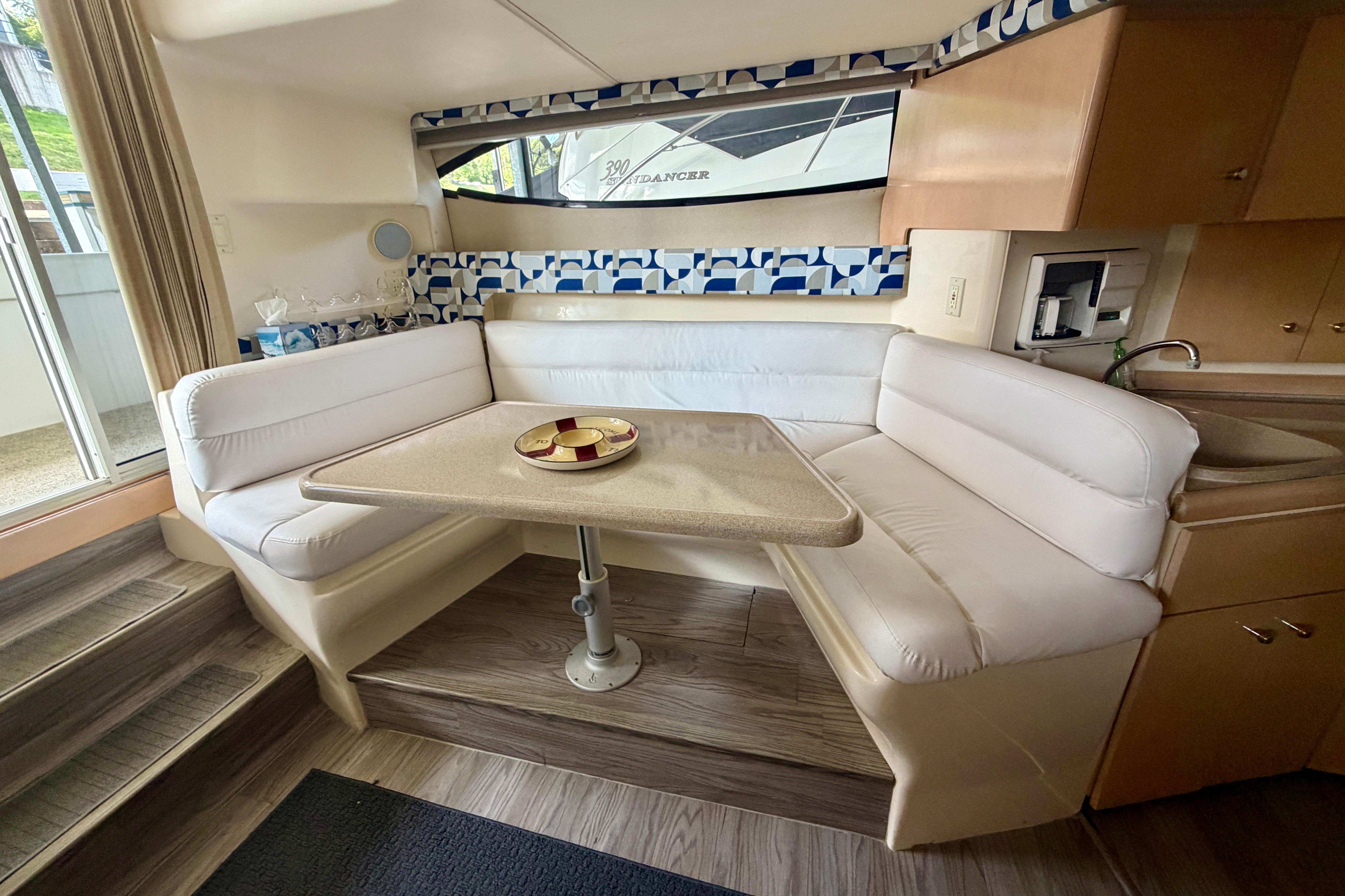 Interior of a 2000 Carver 350 Mariner yacht with a cozy dining area.