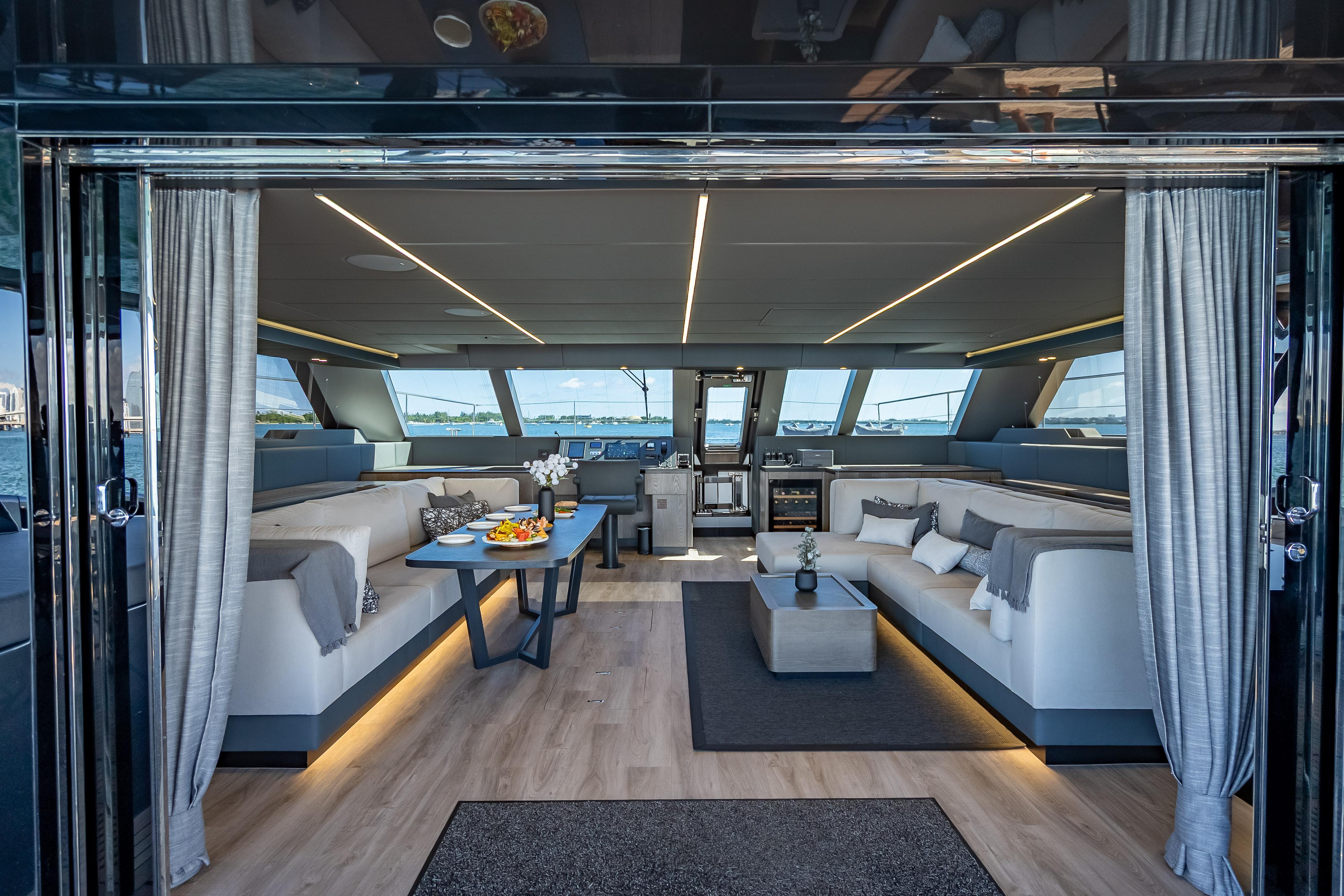 Luxurious interior of 2026 Sunreef 60 Power yacht with modern furnishings and panoramic windows.