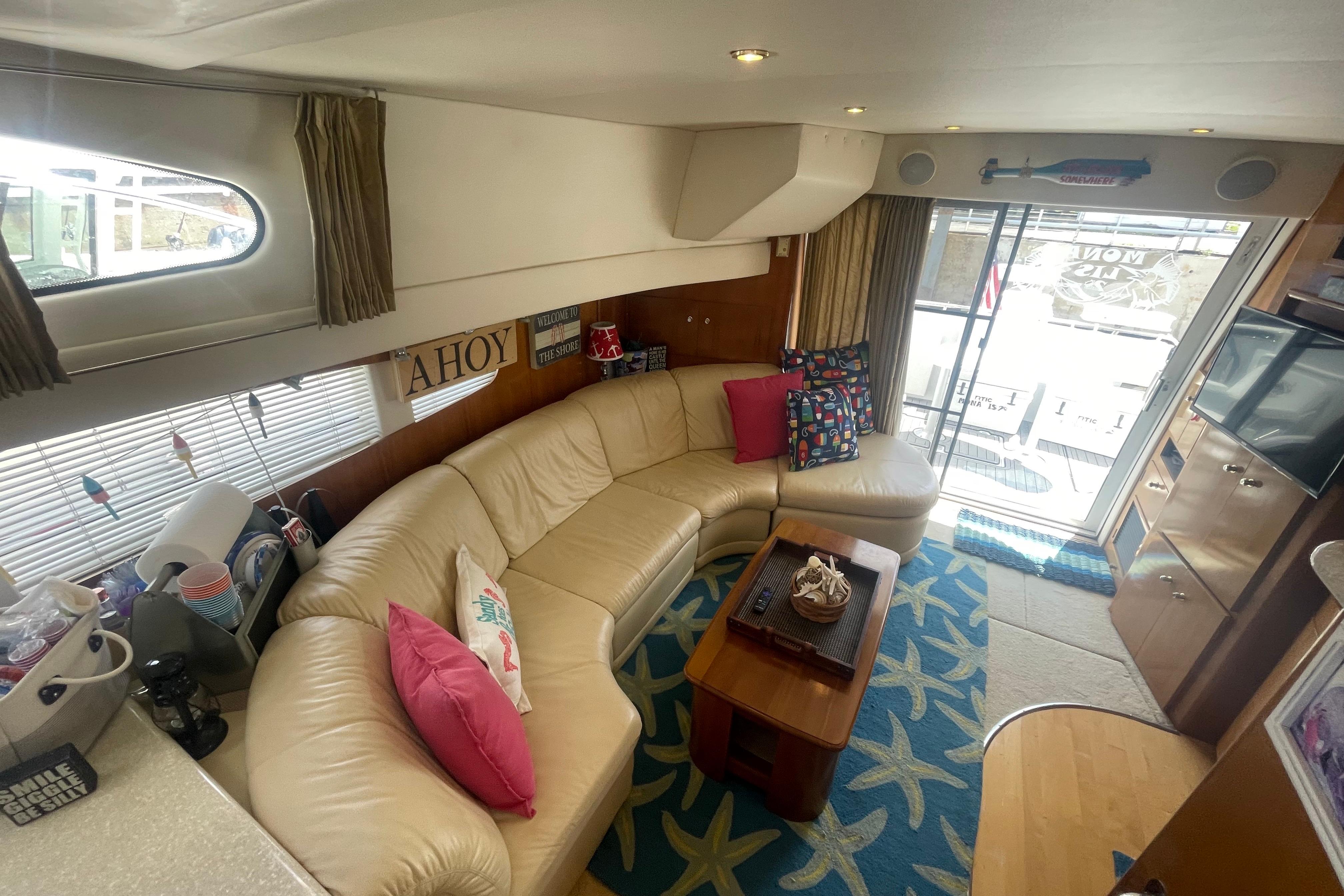 Interior of 2002 Carver 410 Sport Sedan with cozy seating and nautical decor.