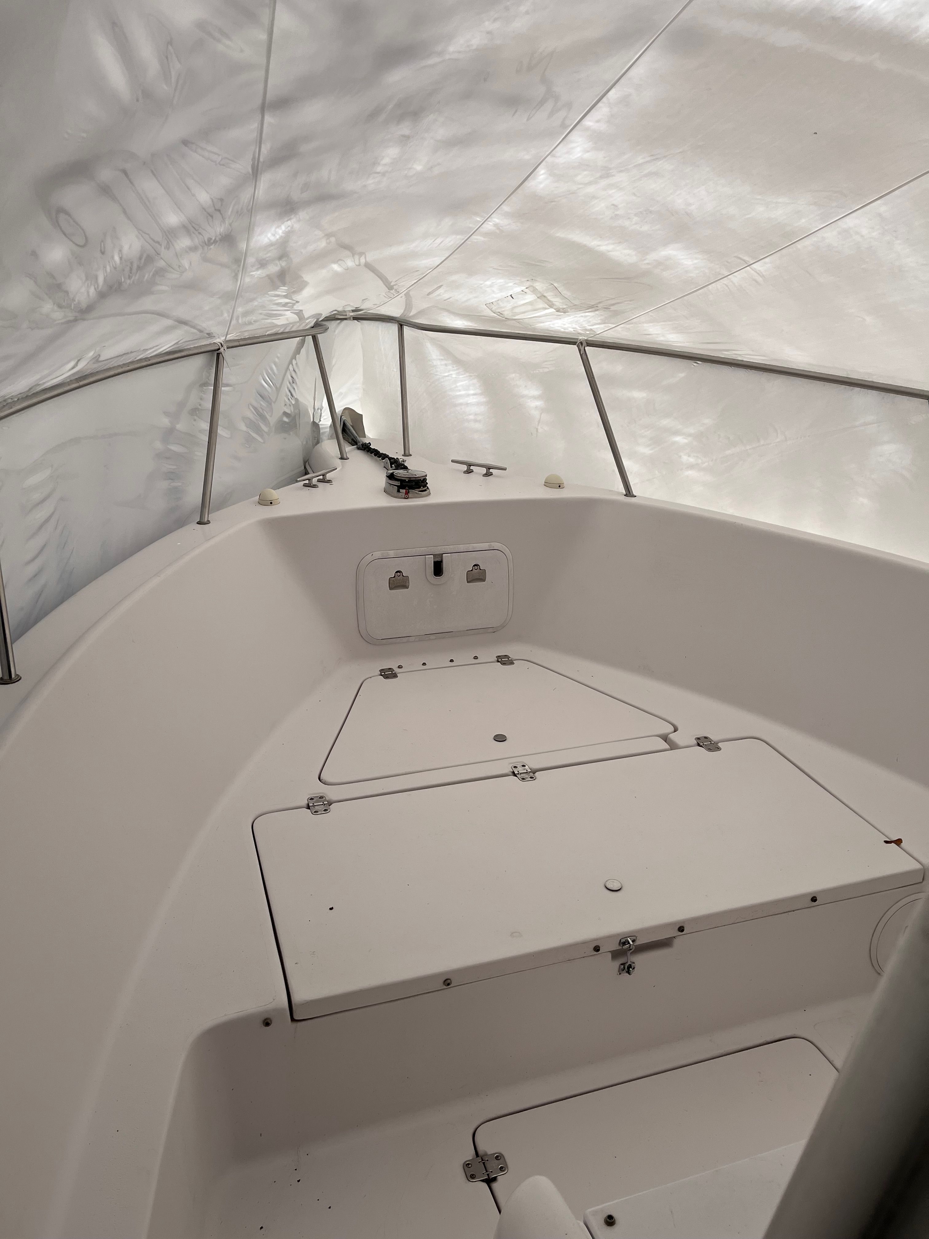 The image shows the bow of a 2002 Pro-Line Center Console boat, under a cover.