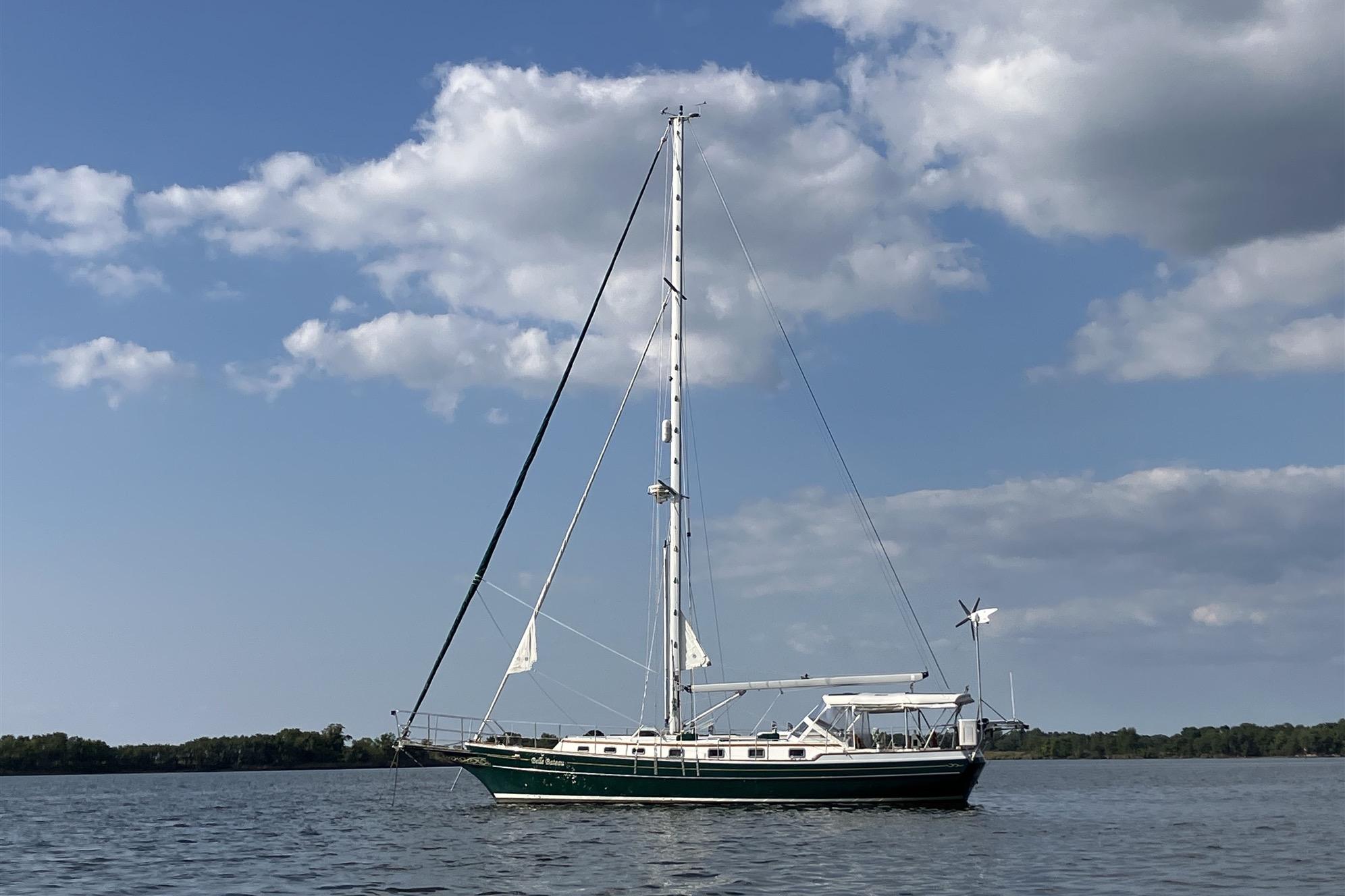 Sailboat on calm water, 1997 Gozzard 44, under a partly cloudy sky.