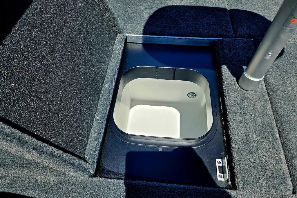 Livewell compartment in 2026 Skeeter ZXE20 boat, featuring carpeted deck and storage.