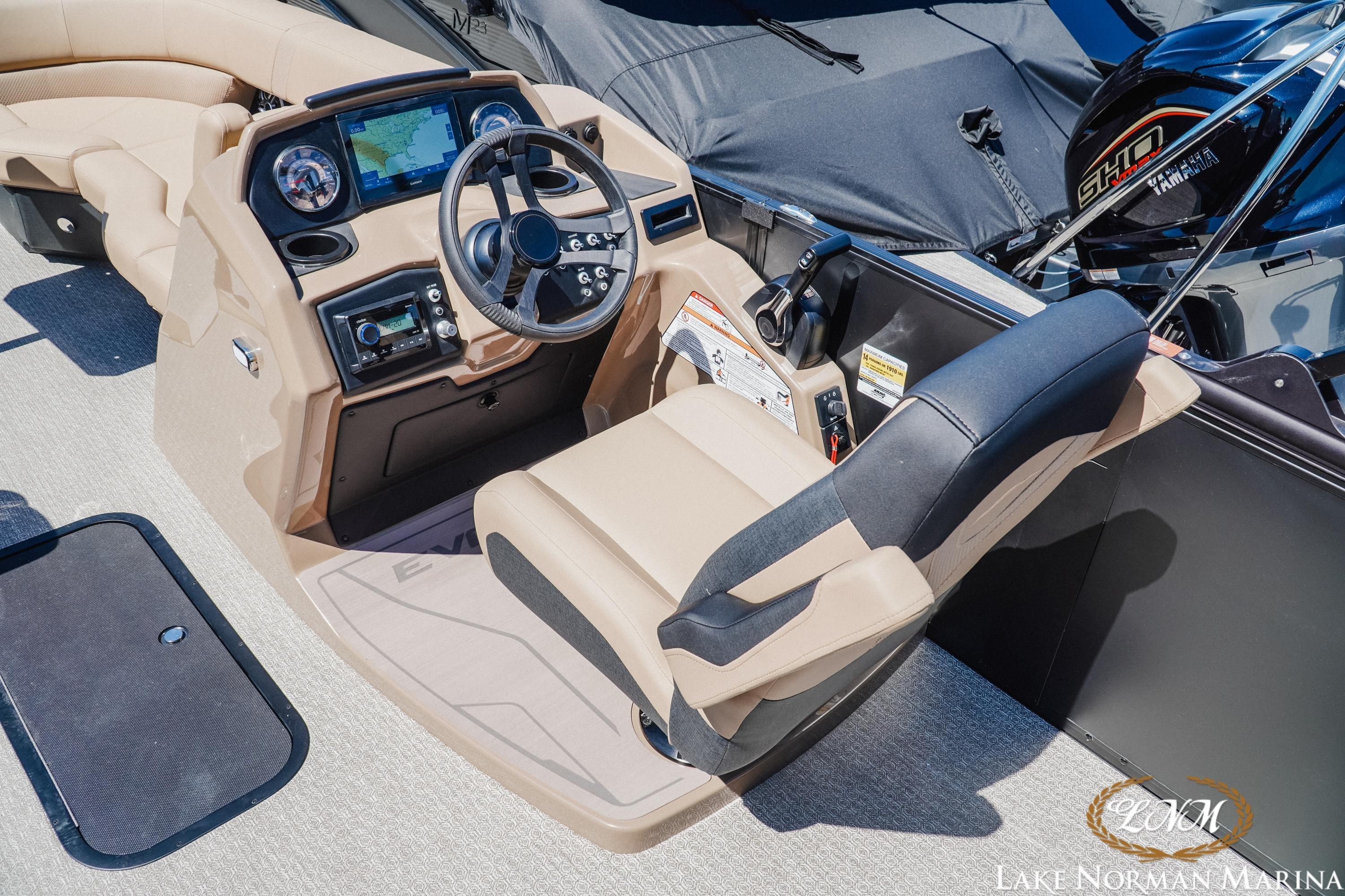 Cockpit of 2026 Evotti 523CS boat with steering wheel and navigation display.