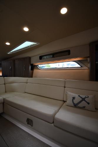 Luxurious interior of 2021 Regal 35 Sport Coupe with plush seating and nautical decor.