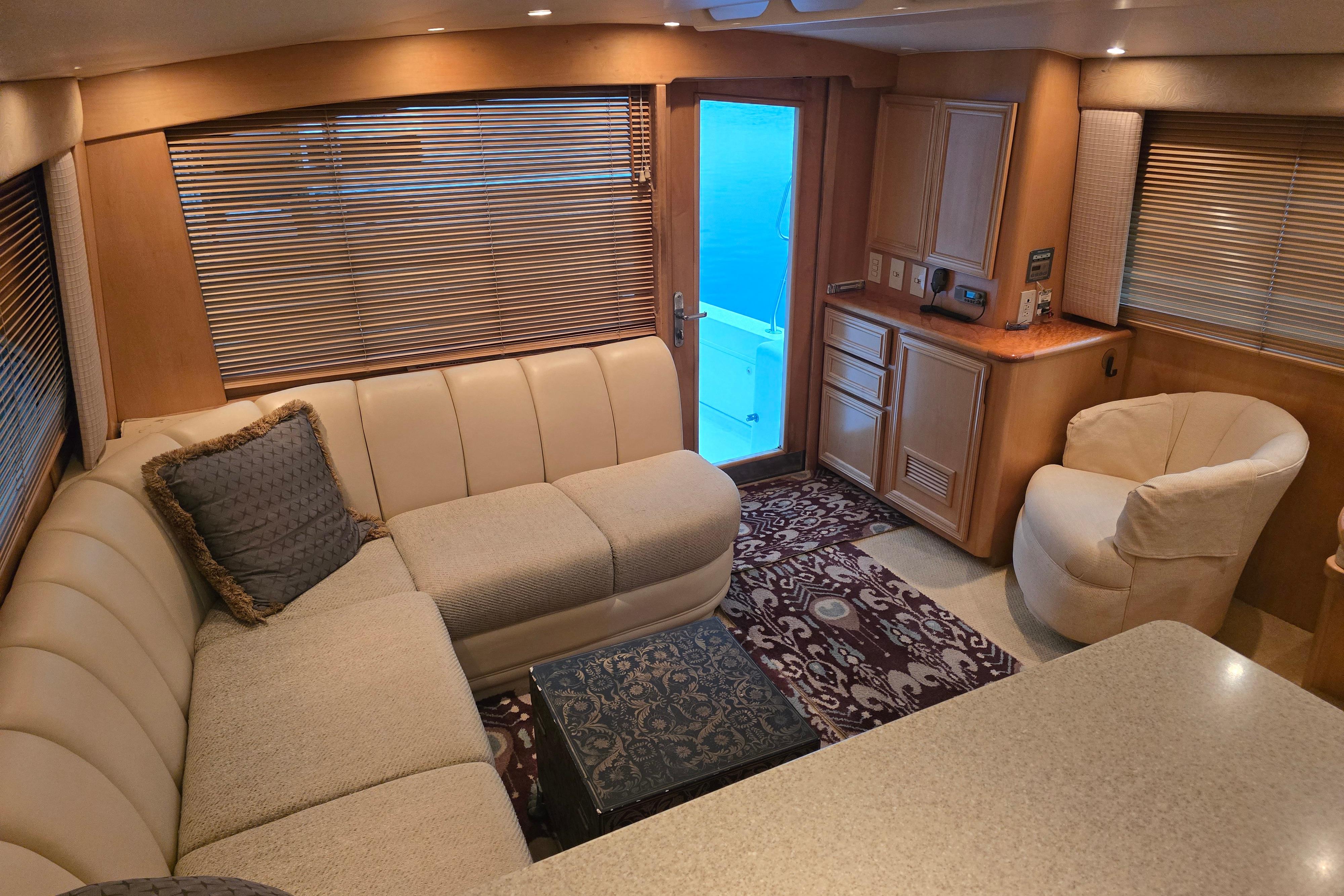 Luxurious interior of a 2001 Cavileer 53 Convertible yacht with plush seating and elegant decor.