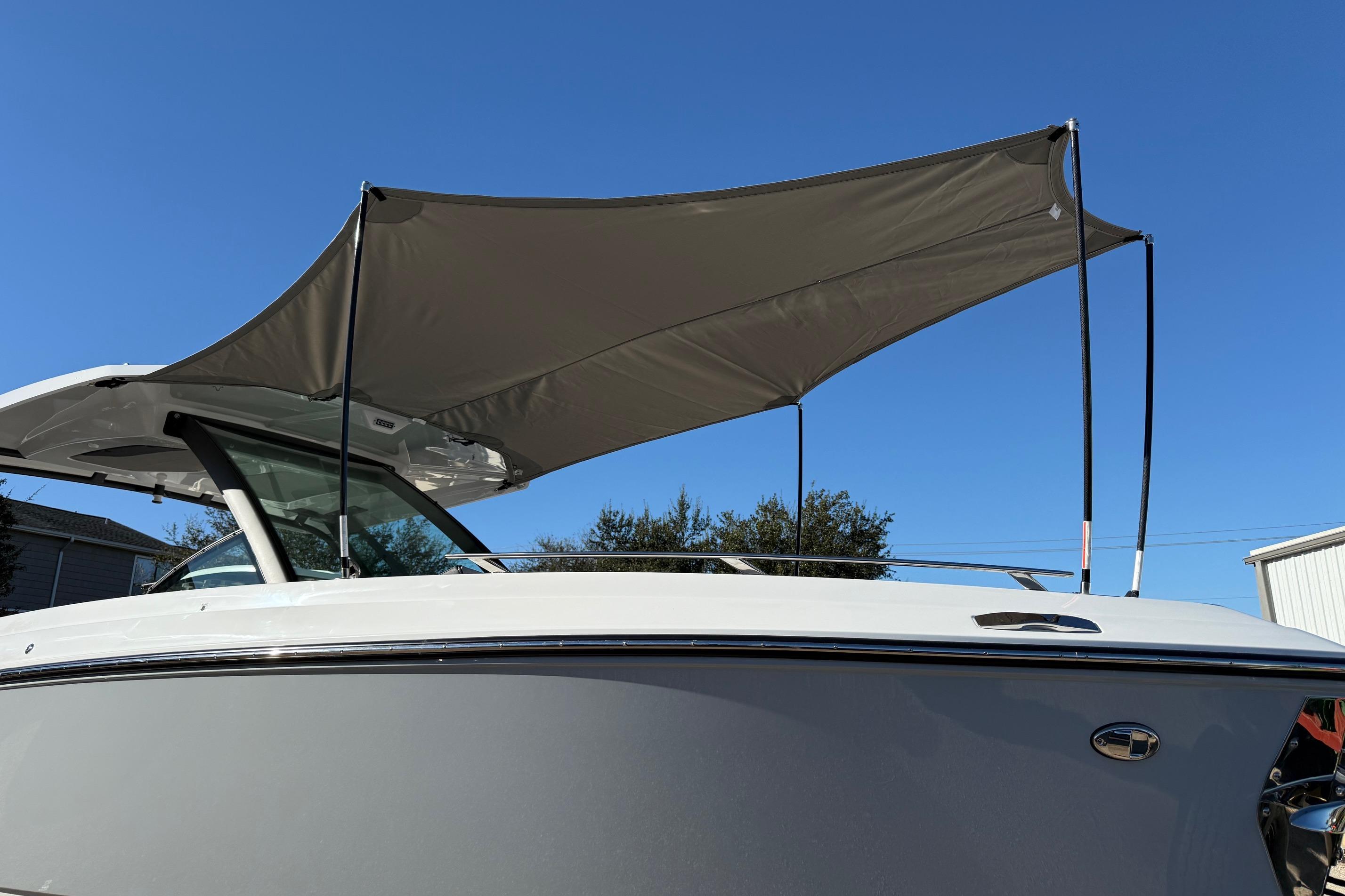 2026 Monterey Elite 30 OB with sunshade, side view.