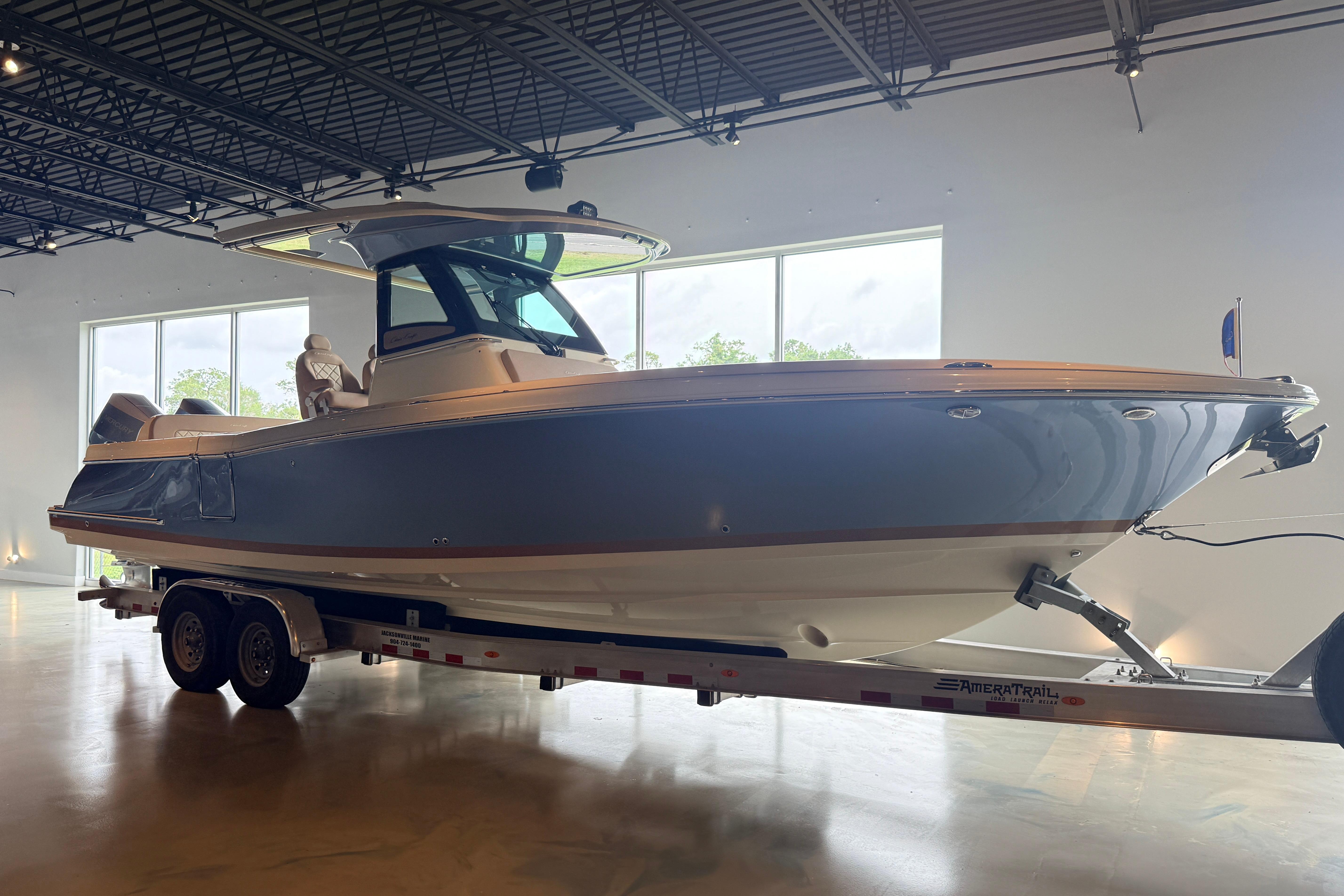 2024 Chris-Craft Catalina 30 boat on trailer in showroom setting.