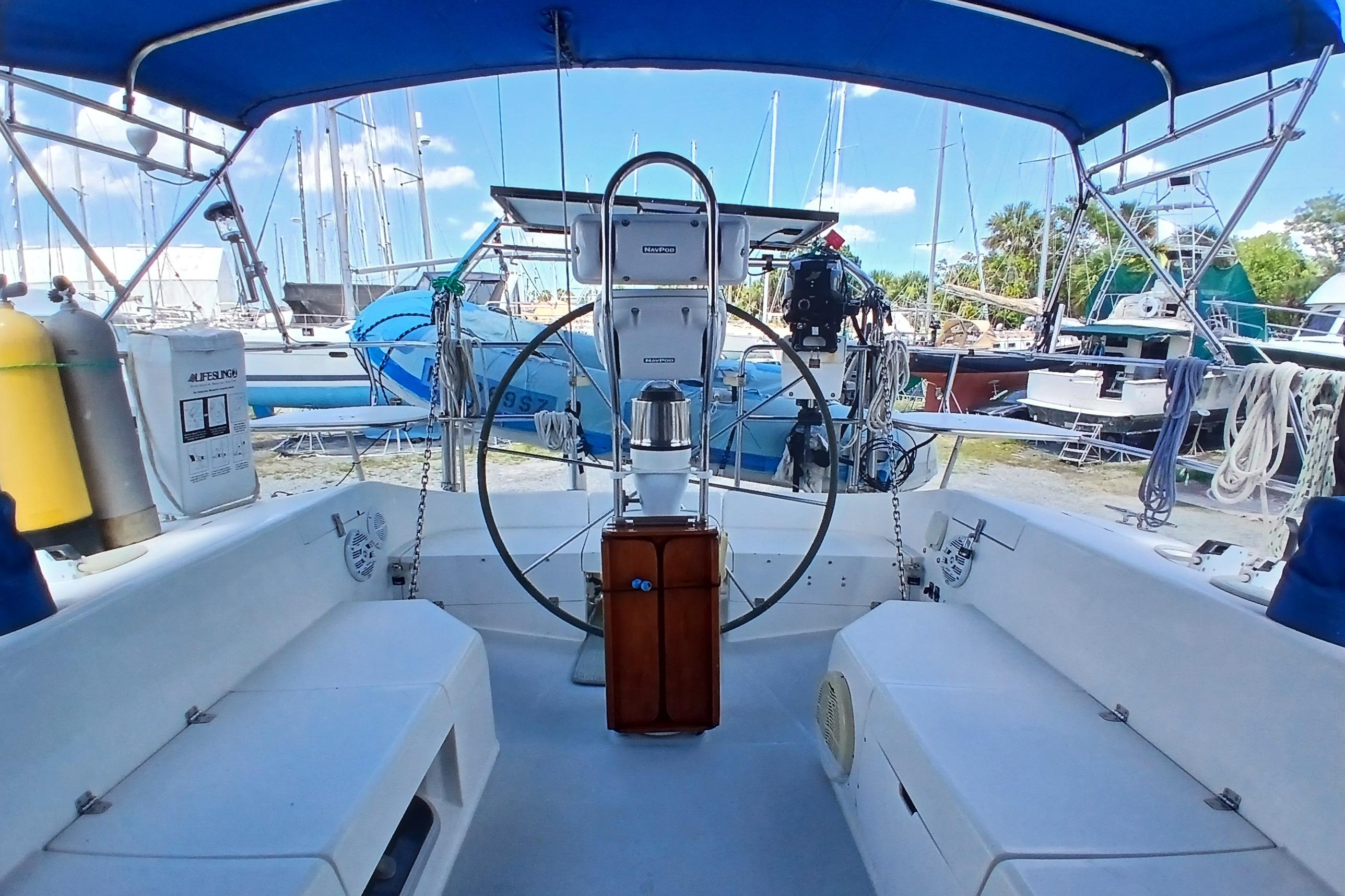 Cockpit view of a 1995 Catalina 42 MkII sailboat in a marina setting.