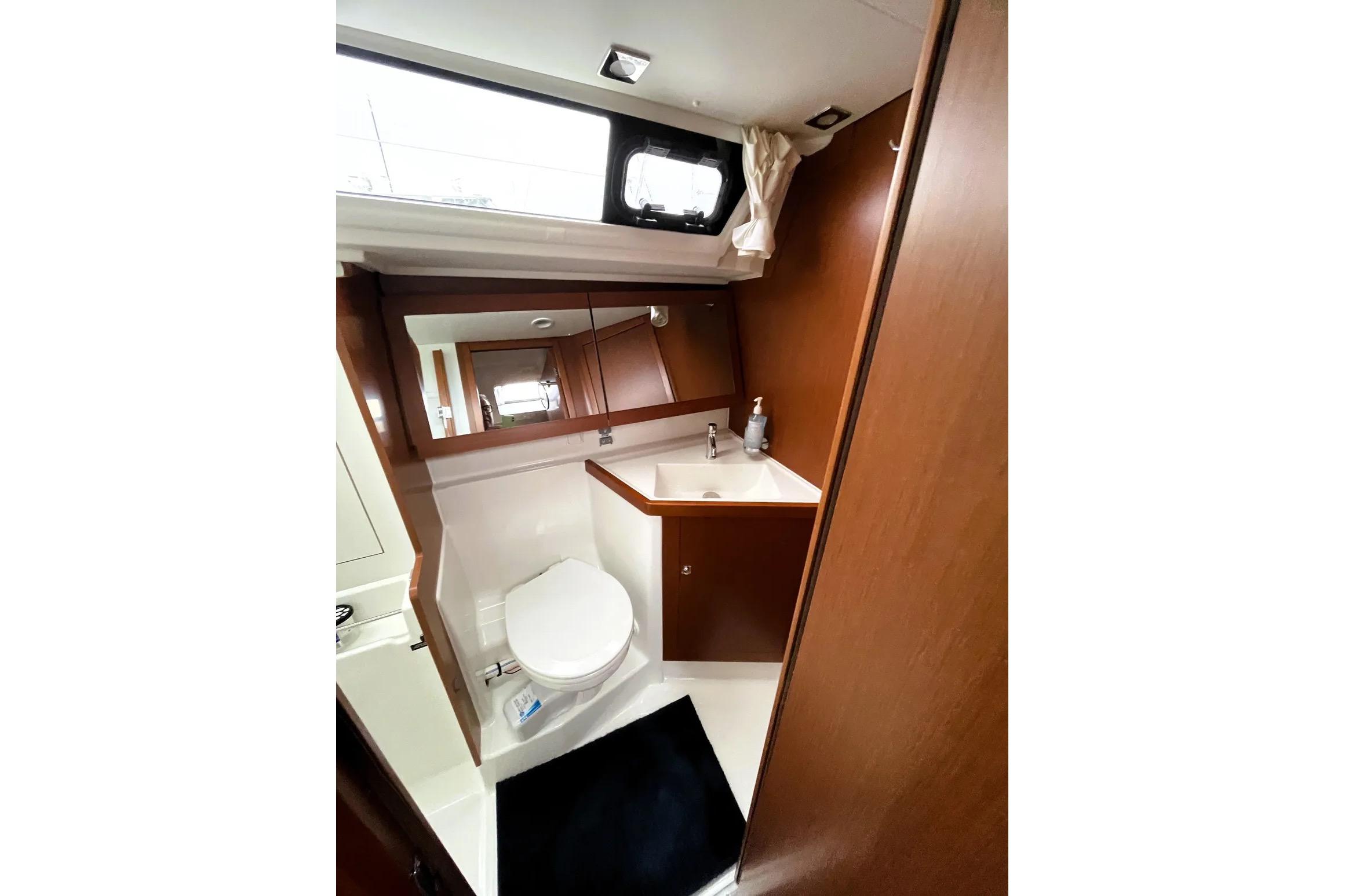 Bathroom interior of 2018 Beneteau Oceanis 45 yacht, featuring modern fixtures and wood accents.