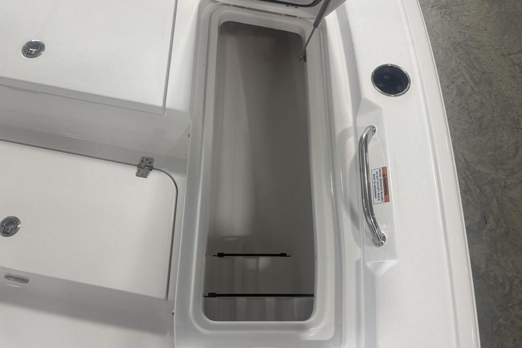 Open storage compartment on 2026 Sportsman Masters 227 boat, featuring stainless steel handle.