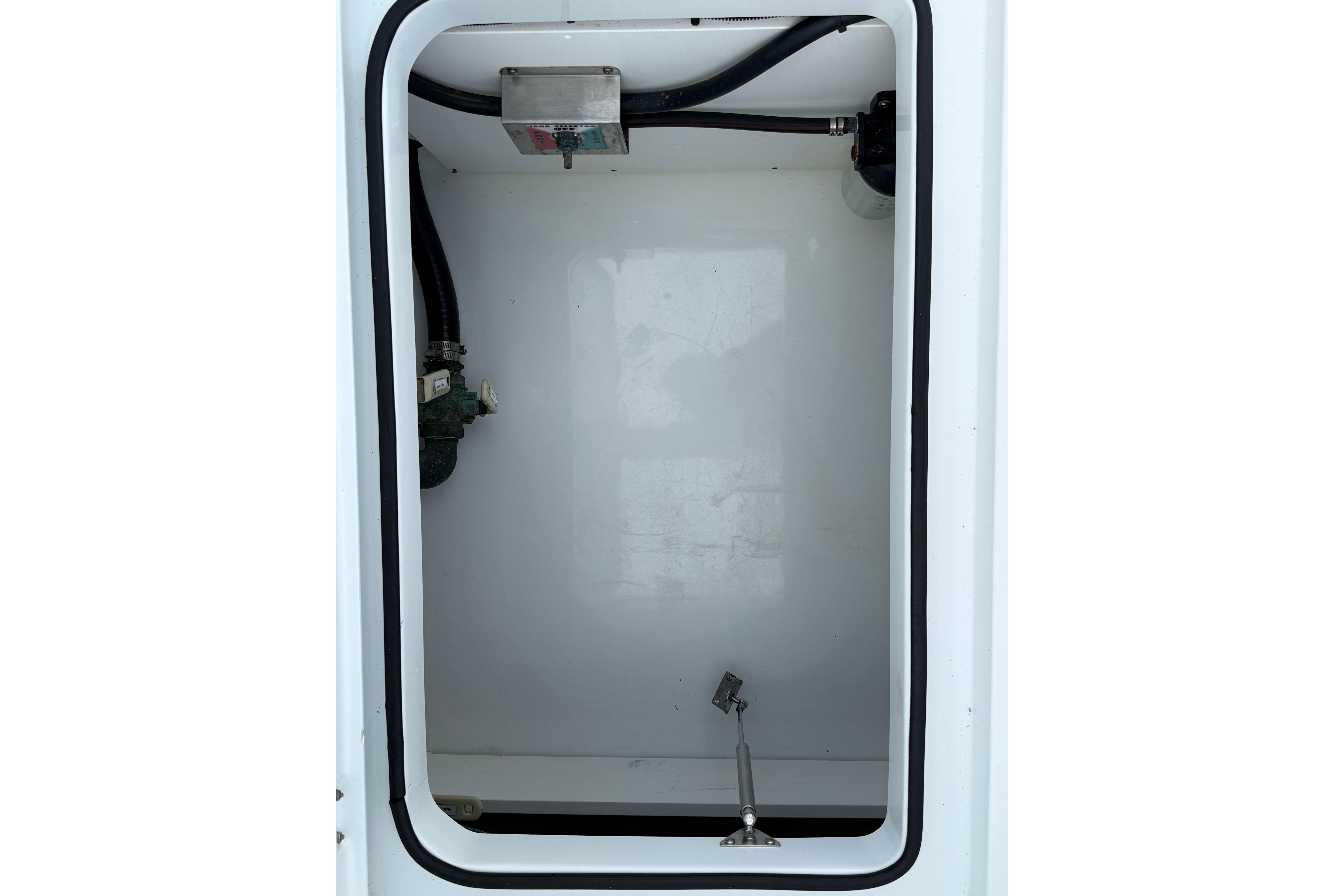 Freeman 34VH 2022 boat compartment with hoses and fittings.