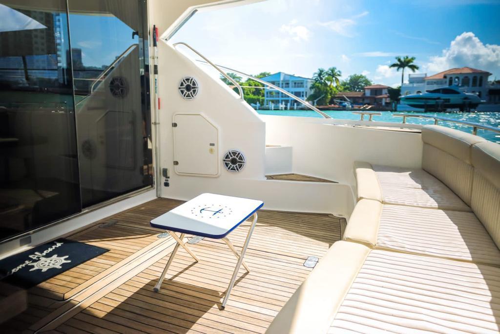 Luxury 2006 Fairline 50 yacht deck with seating, table, and scenic waterfront view.
