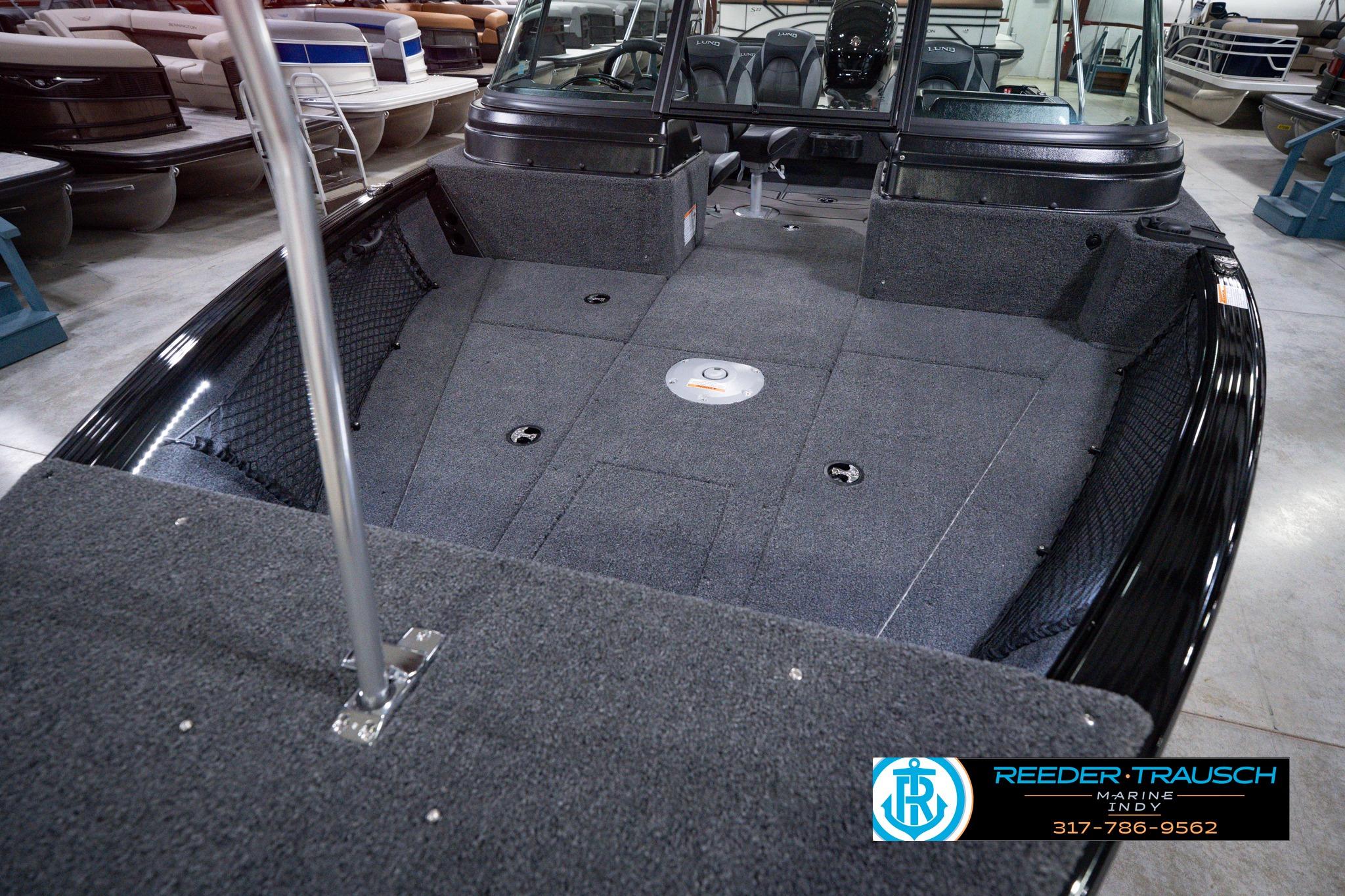 2026 Lund 1875 Impact XS SS boat interior with carpeted deck and seating.