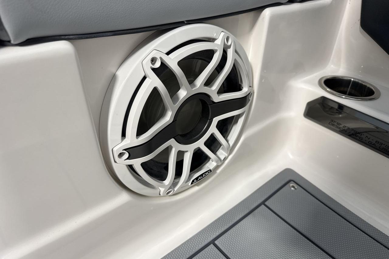 Close-up of a speaker in a boat, surrounded by gray and white interior.