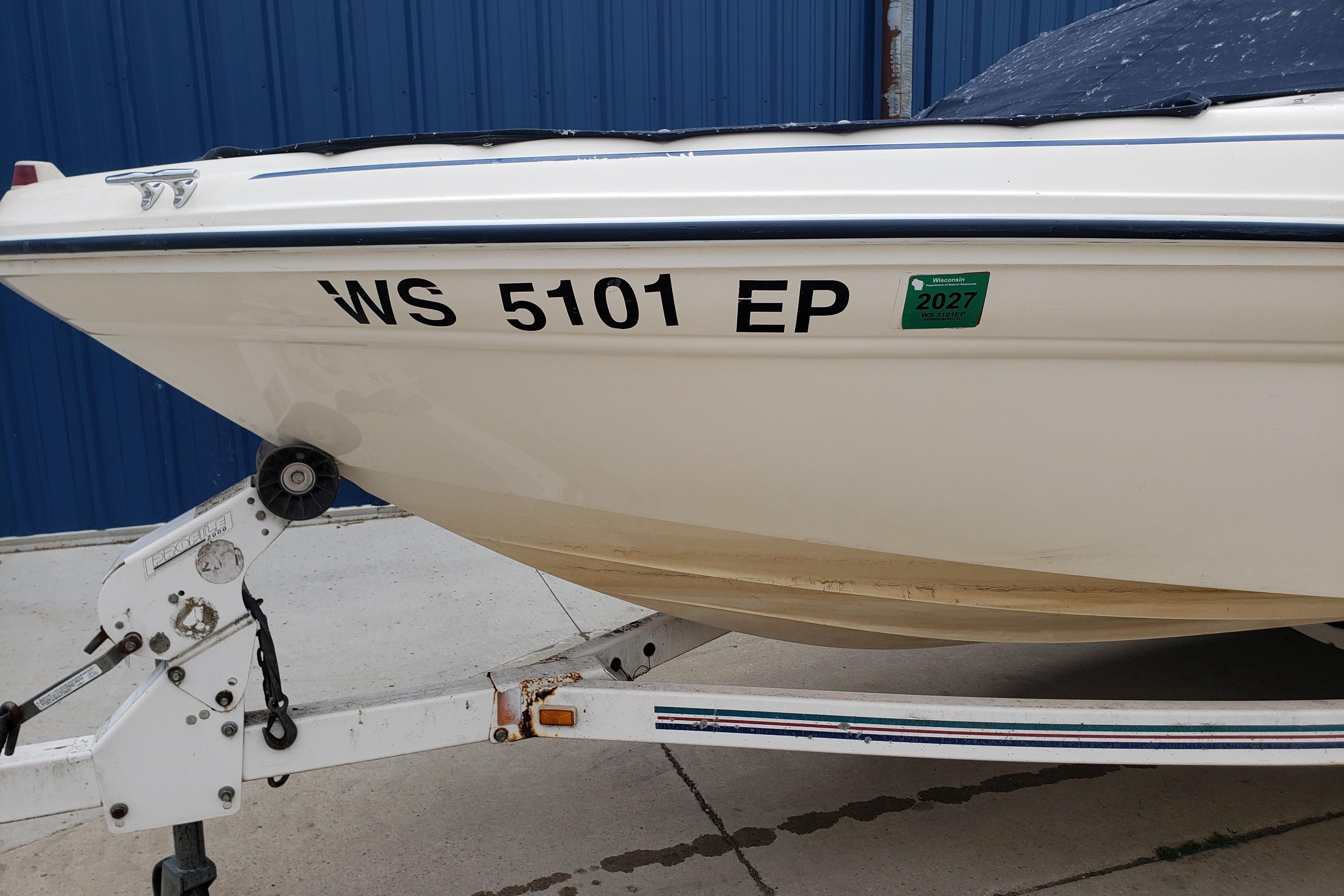 1998 Sea Ray 180 Bow Rider boat on trailer, registration WS 5101 EP, blue background.