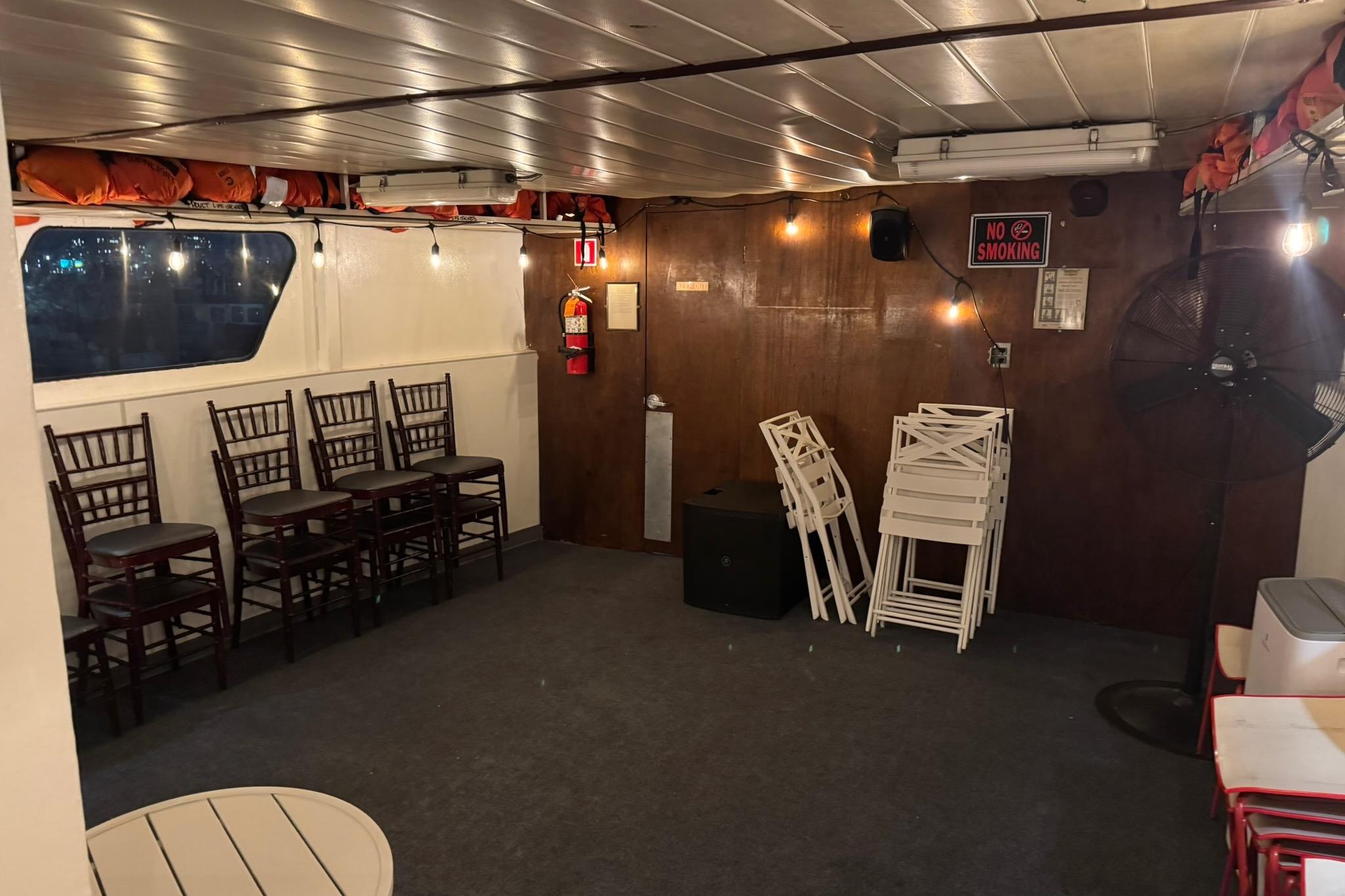 Interior of 1985 Custom Commercial Steel 100 boat with chairs and "No Smoking" sign.