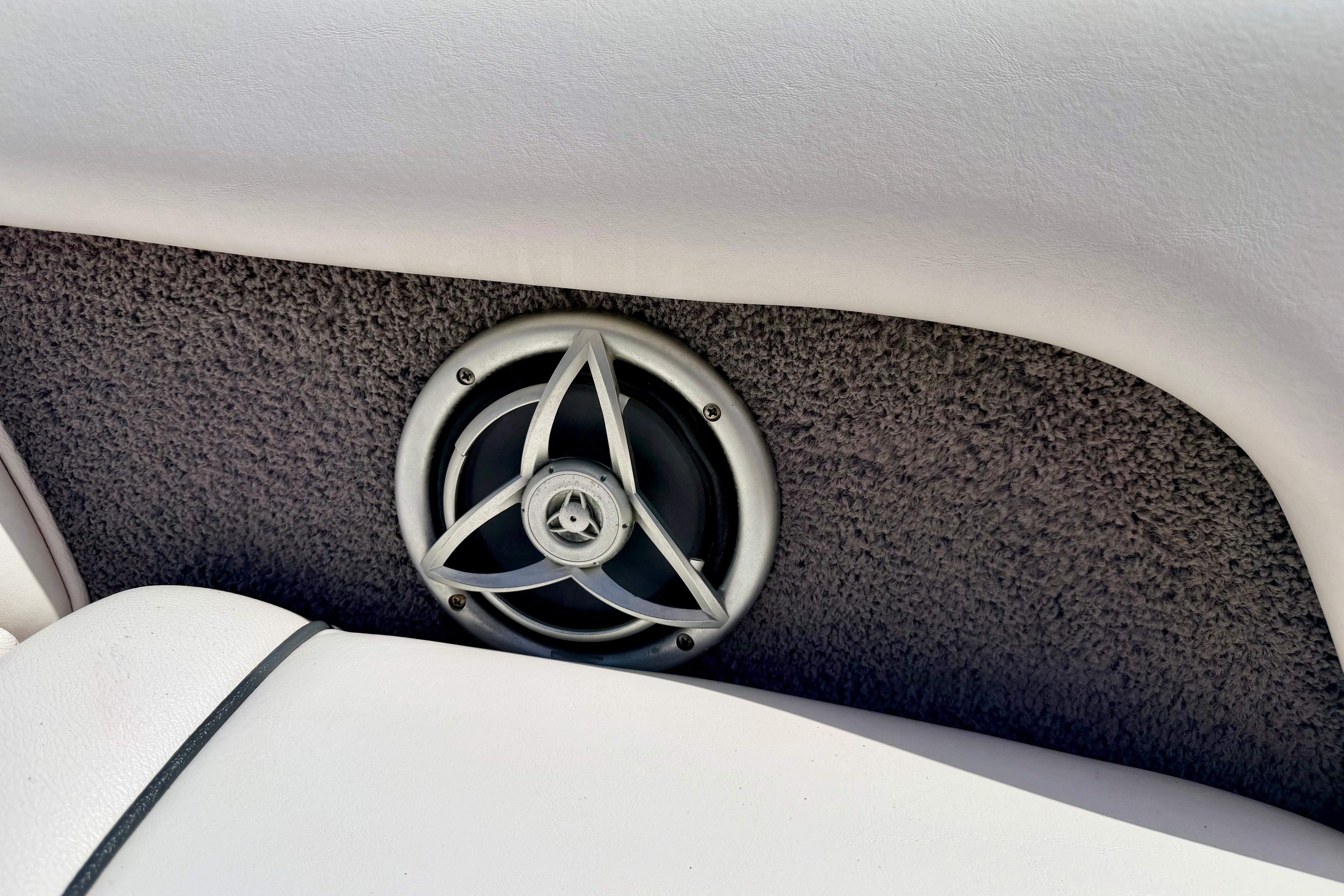 Speaker on 2008 Moomba Outback V boat interior, featuring gray carpet and white upholstery.
