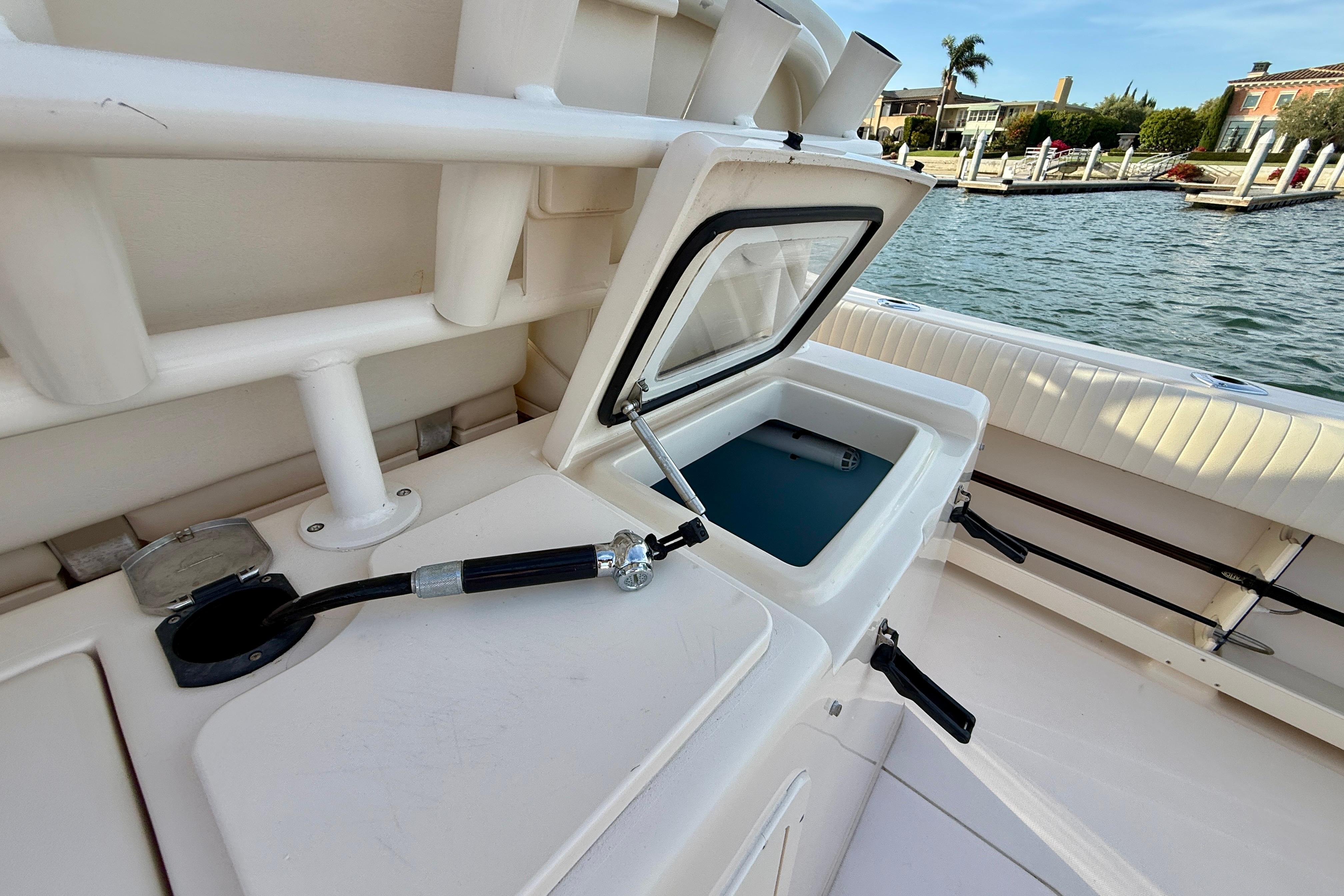 2012 Grady-White Canyon 336 boat with open storage compartment by the water.