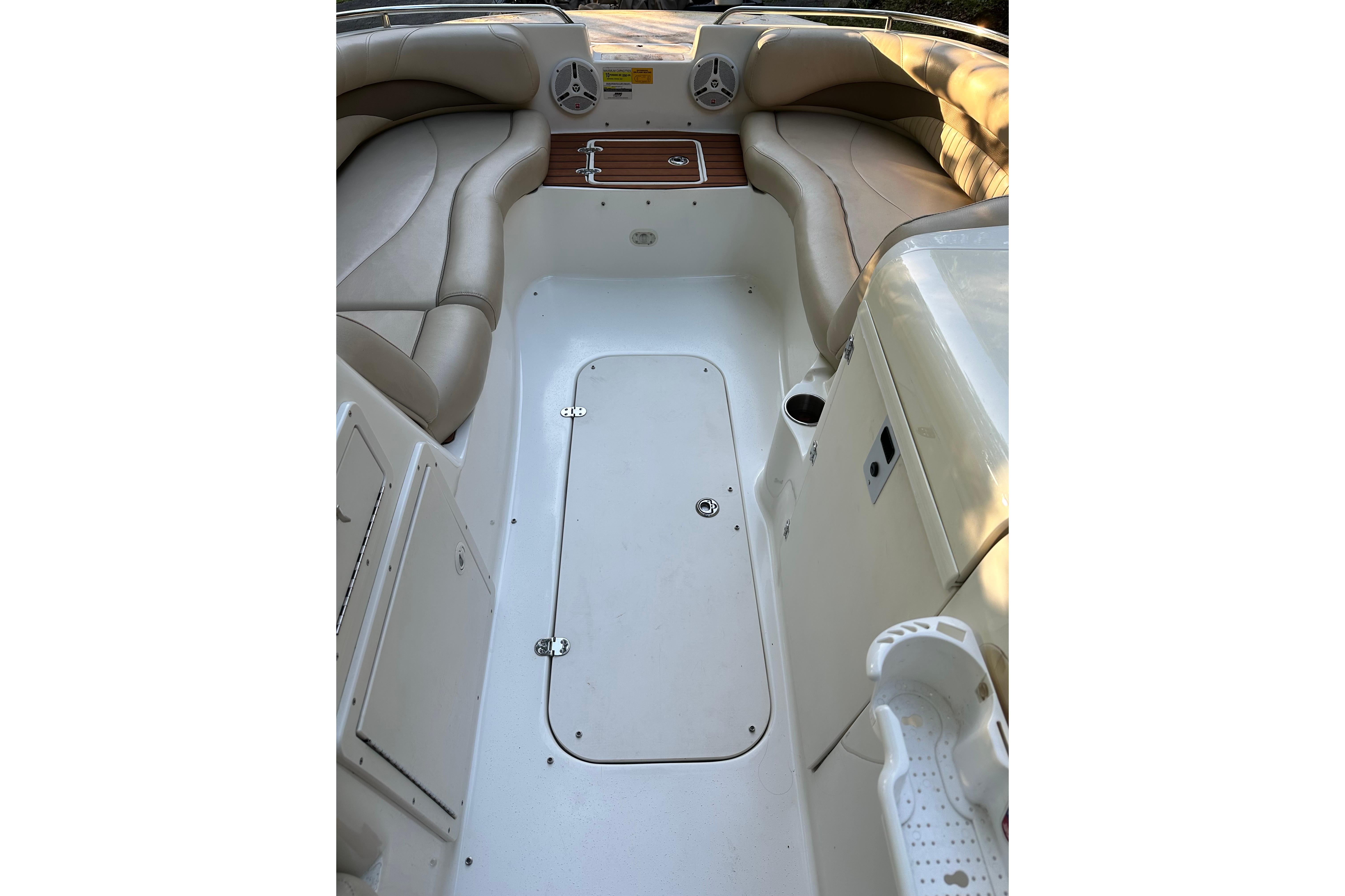 2008 NauticStar 230 SL Sport Deck I/O interior with beige seating and white deck.