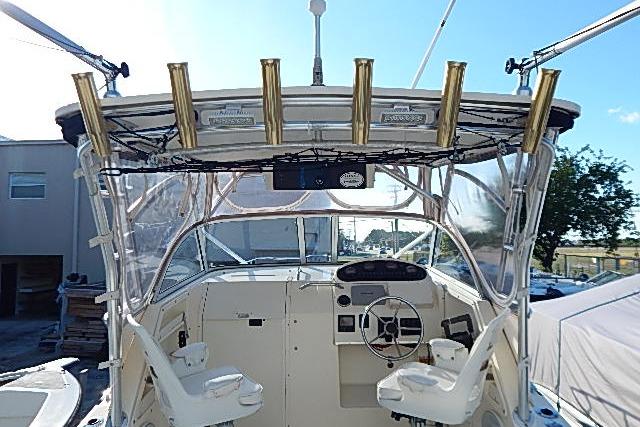 2003 World Cat 270 EC boat cockpit with dual seats and fishing rod holders.