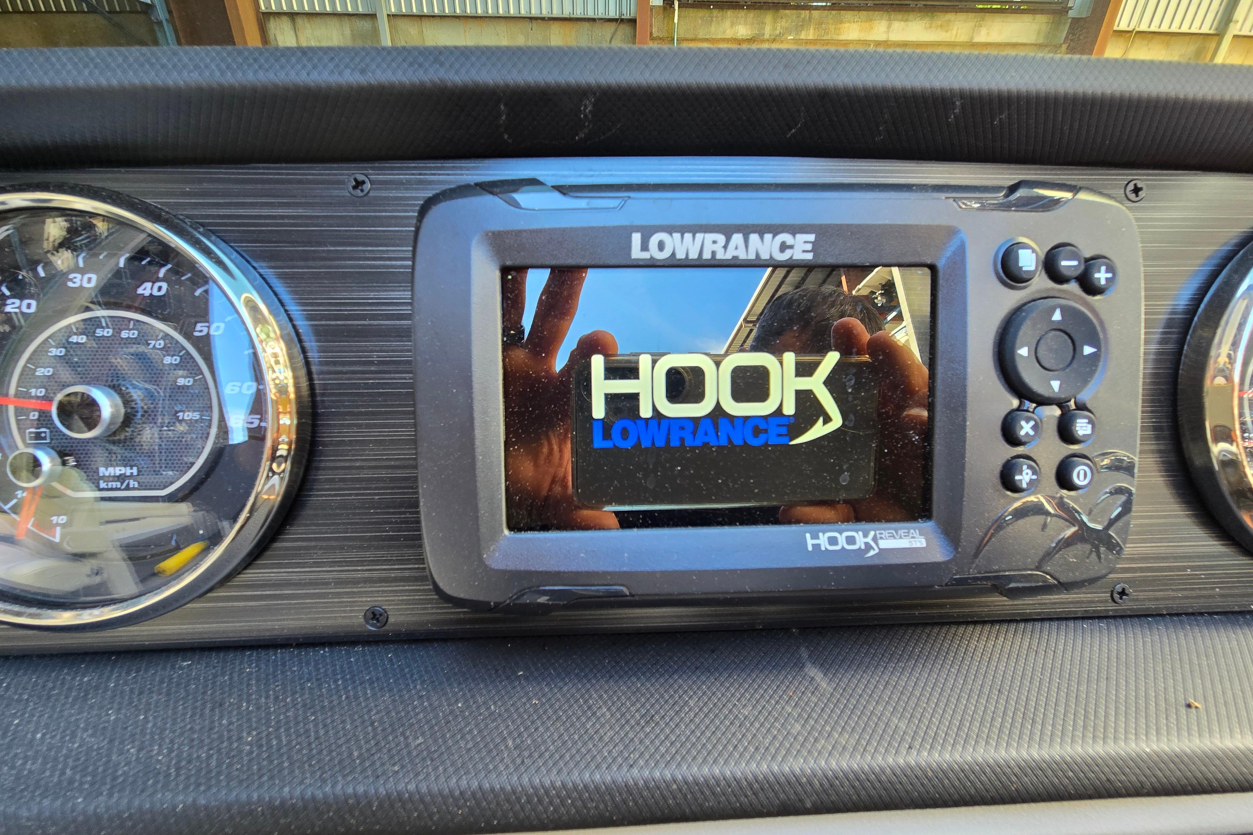 Lowrance Hook Reveal GPS on 2024 Godfrey Sweetwater 2486 SB dashboard.