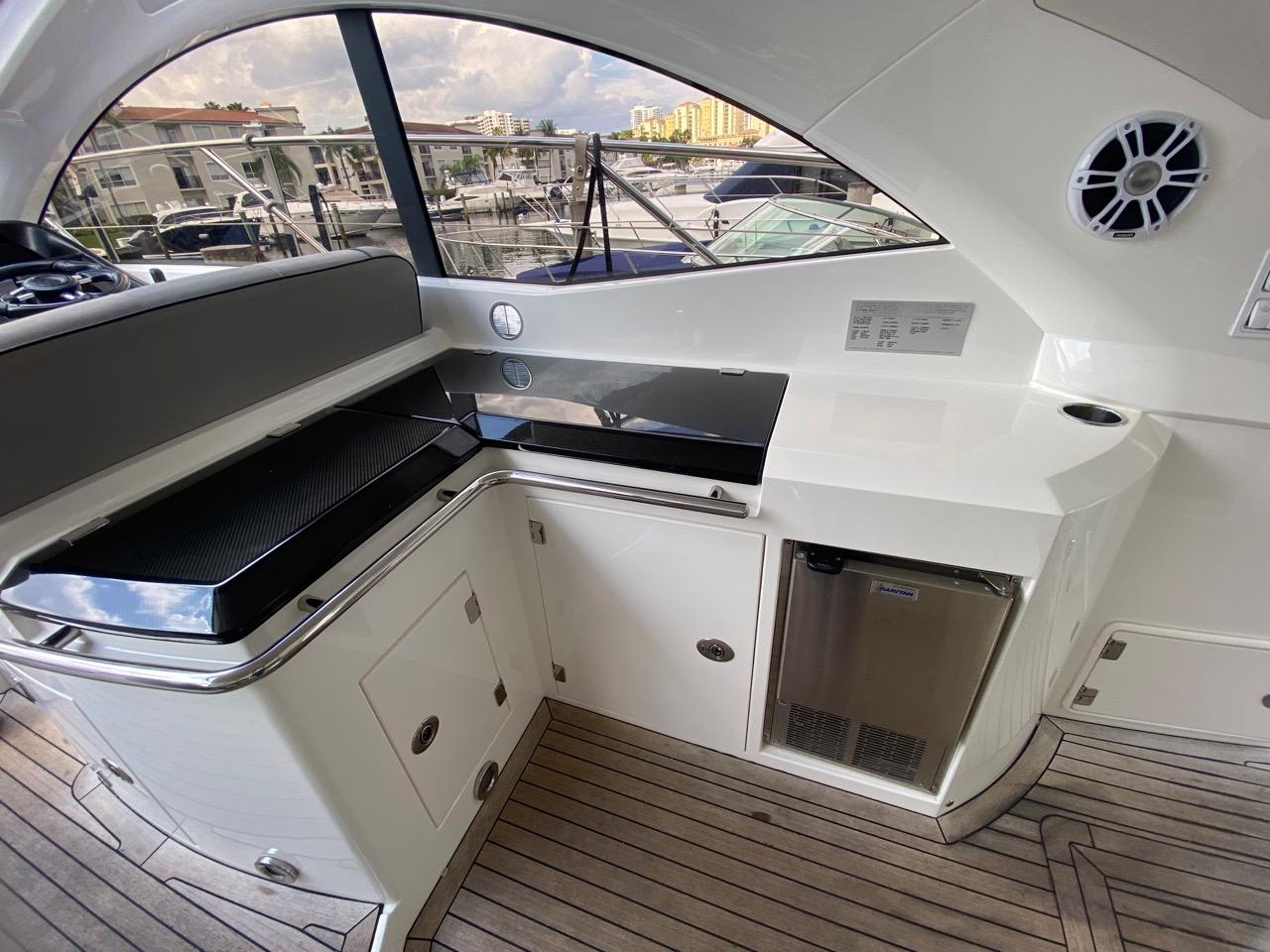 Luxurious 2014 Sunseeker 48 Portofino XPS yacht interior with sleek kitchenette and modern amenities.