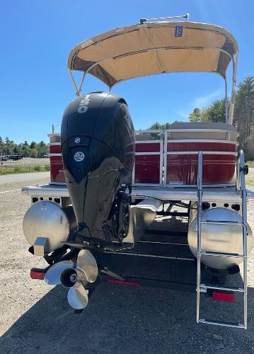 2025 Sun Tracker Party Barge 22 RF DLX pontoon boat with outboard motor and canopy.