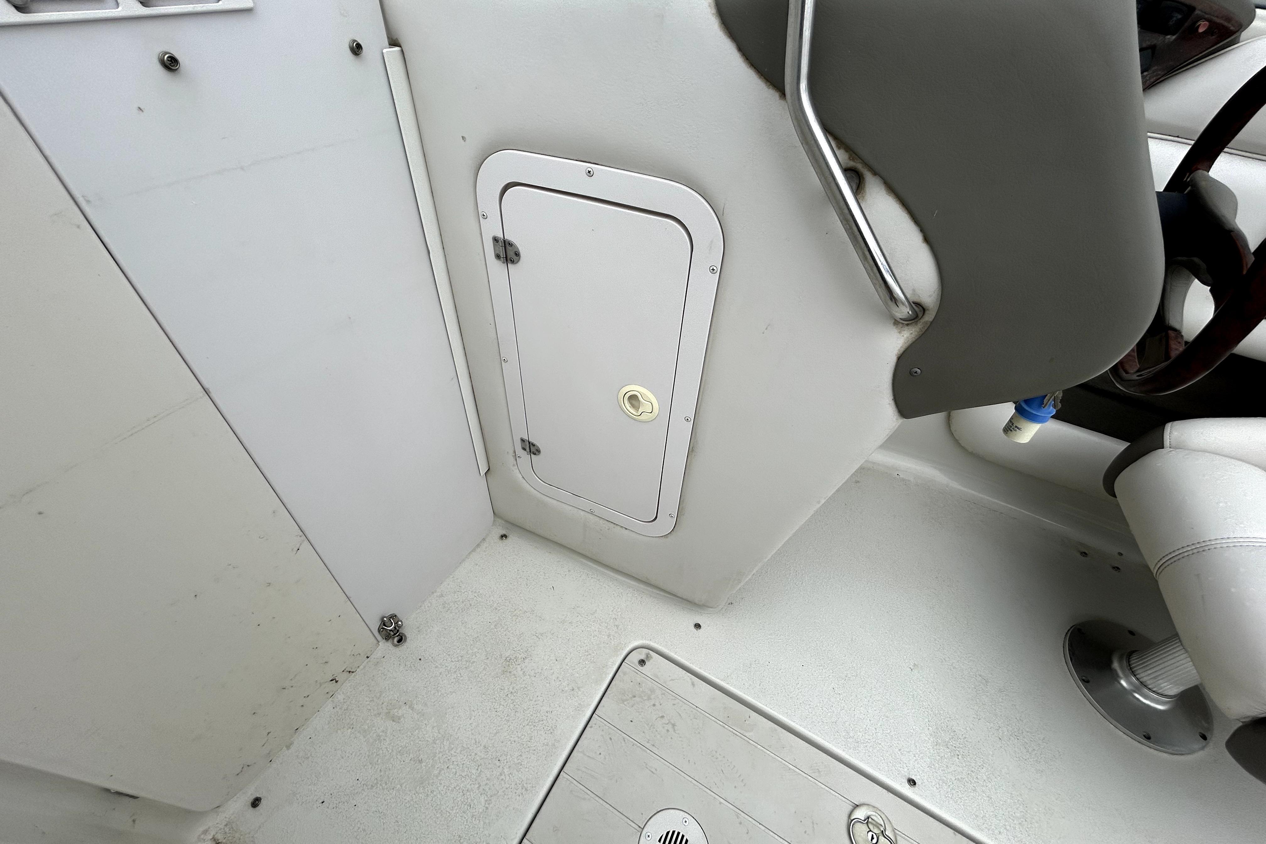 2001 Crownline 239 DB boat interior with storage compartment and seating area.