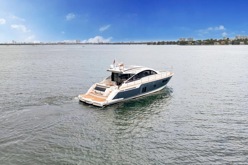 2012 Fairline Targa 58 yacht cruising on calm waters under a clear blue sky.