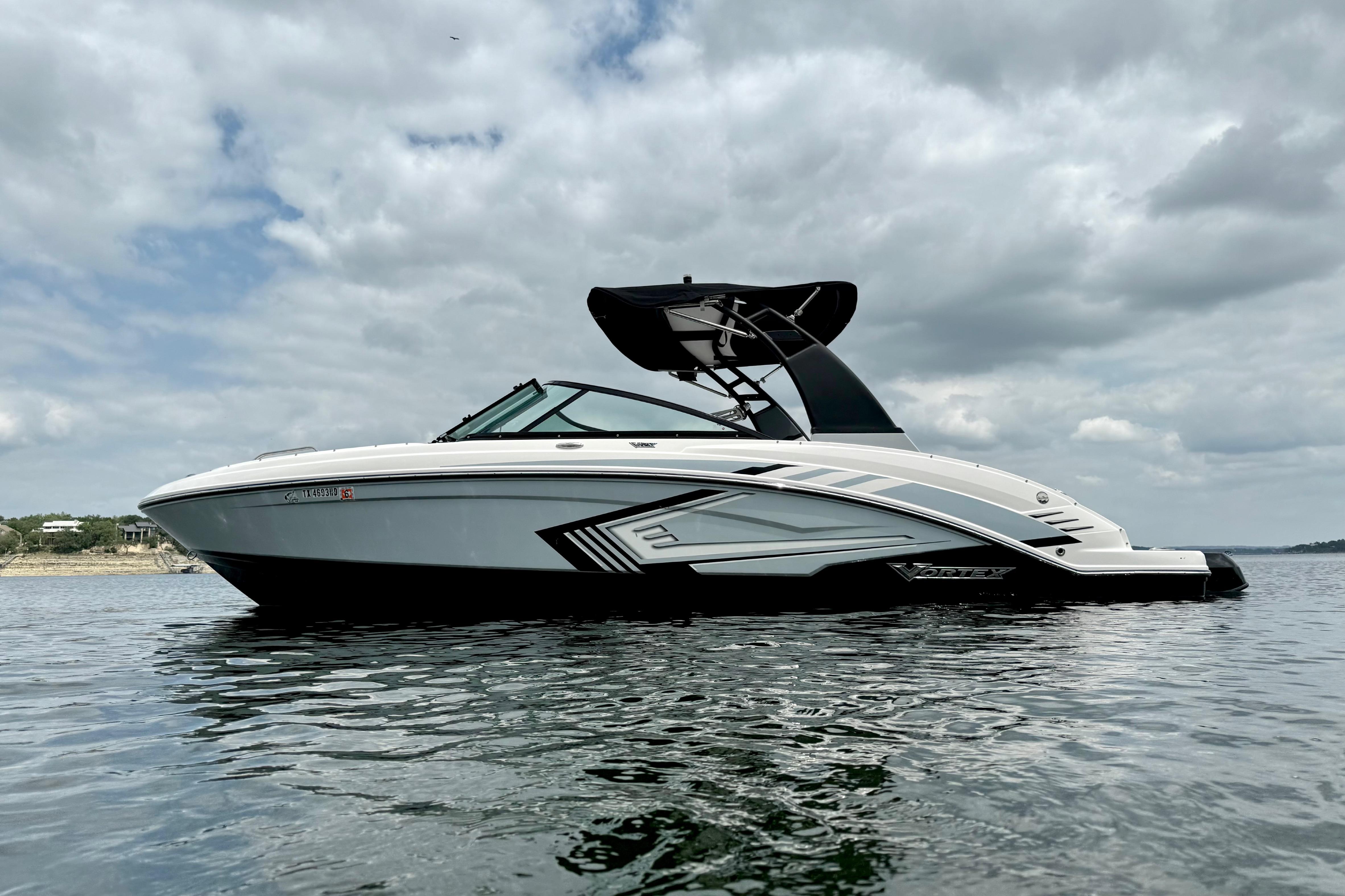 2019 Chaparral Vortex 223 VRX boat on calm water under cloudy sky.
