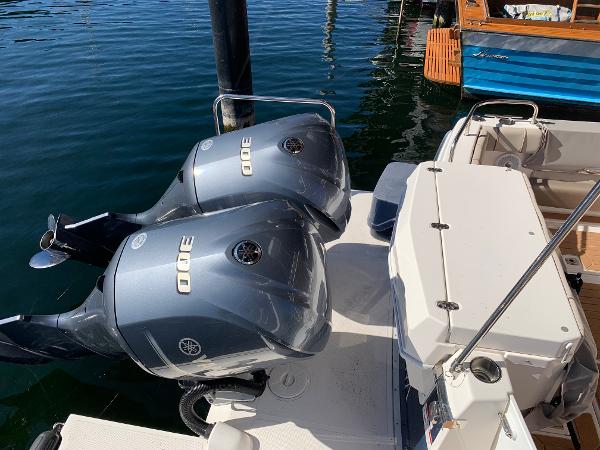2021 Cutwater C-32 CB boat with dual outboard engines docked on calm water.