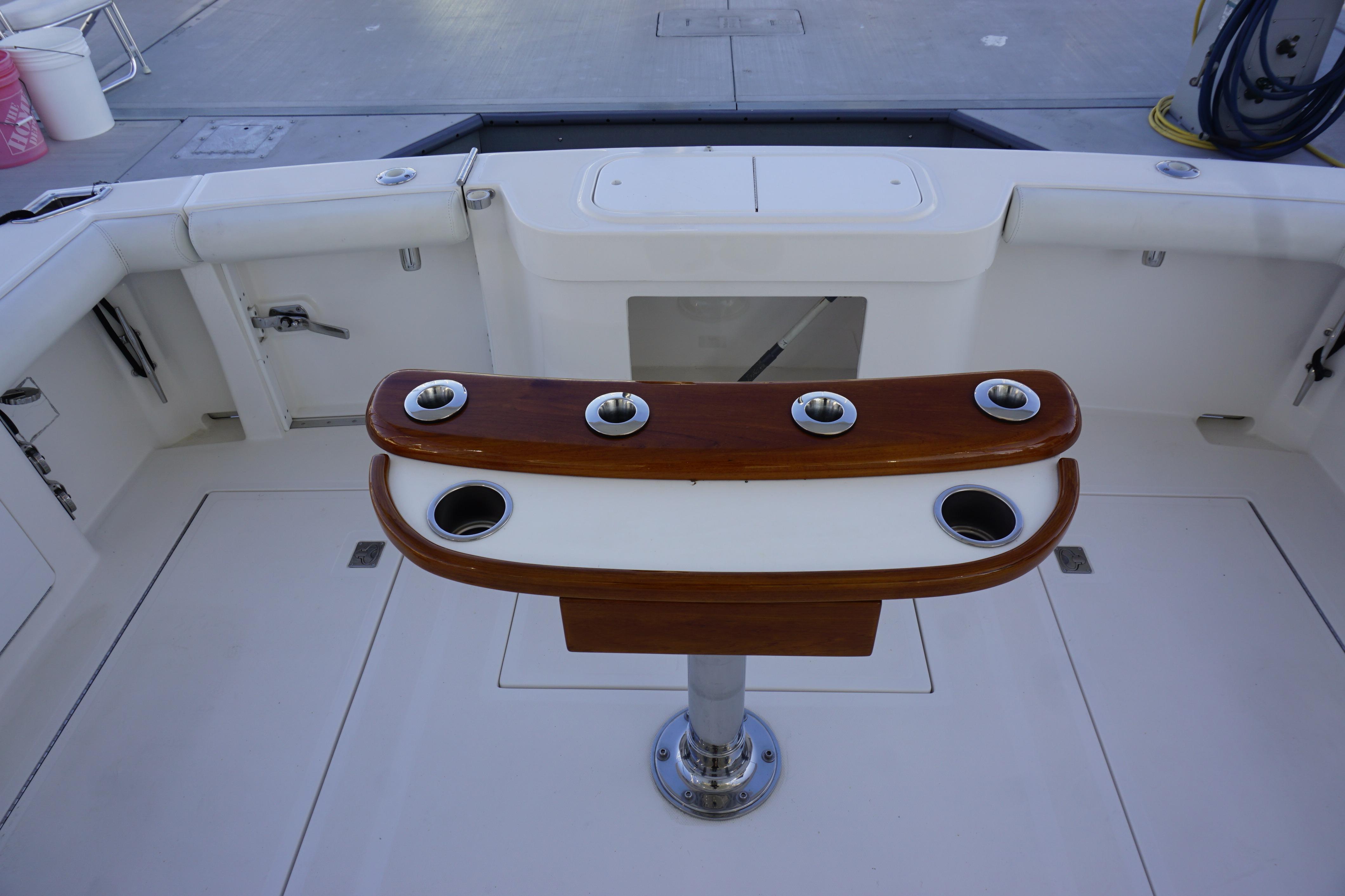2005 Cabo 35 Express boat cockpit with rod holders and clean deck.