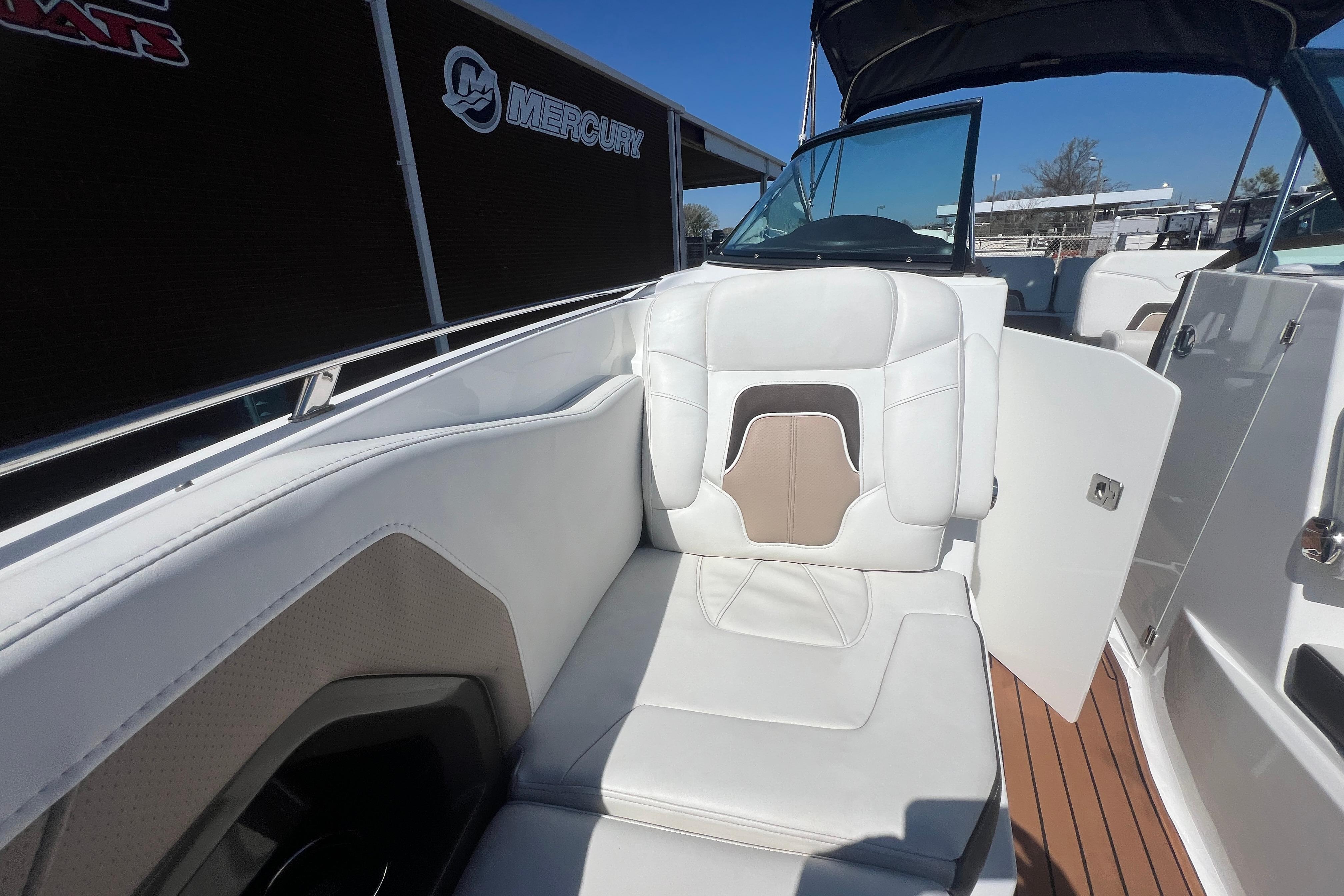 2017 Monterey 298SS Super Sport boat interior with white seating and wood flooring.