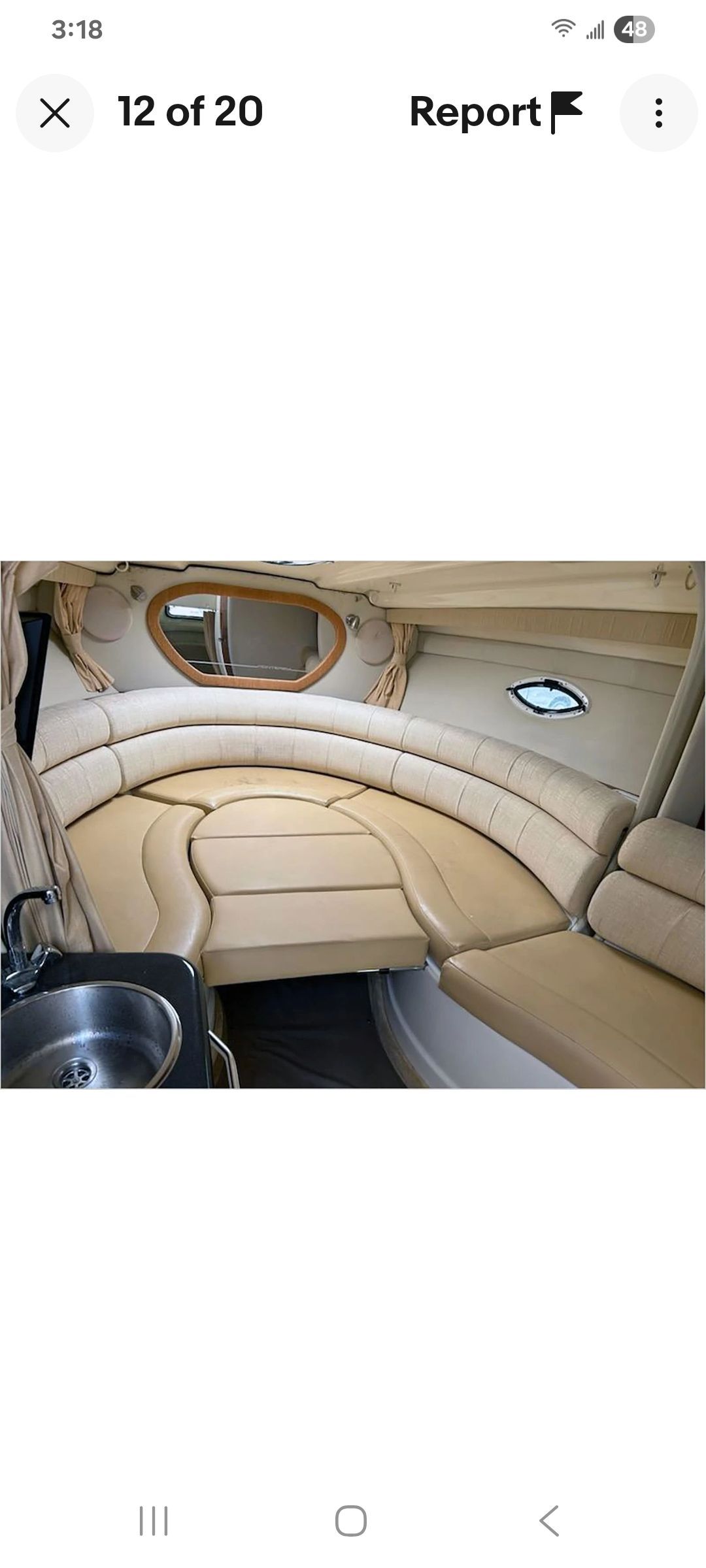 Interior of a Monterey 290 Cruiser with beige leather seating and a small sink.