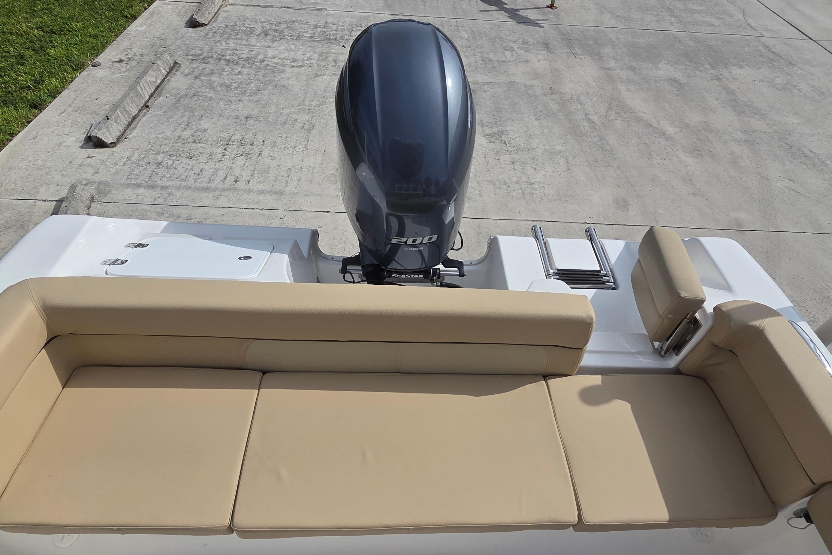 2015 Tidewater 220 LXF boat with beige seating and powerful outboard motor.